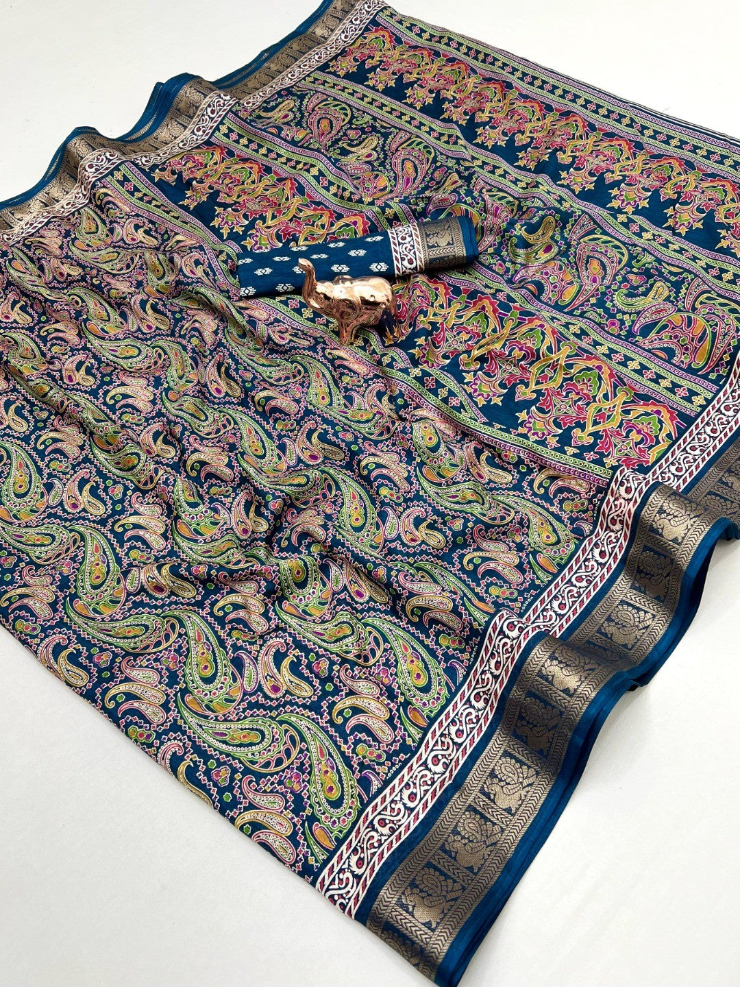 Blue Paisley Printed Dola Silk Saree with Detailed Zari Border and Graceful Fluid Drape - Image 1