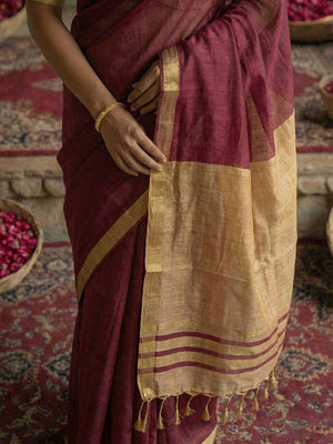 Elegant Wine Solid Cotton Blend Saree Highlighted By Woven Border & Tassel Pallu - Image 2
