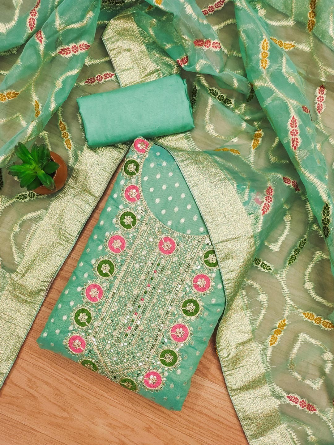 Graceful Turquoise Floral Weaving Shimmer Dress Material Adorned With Cording Sequins Embroidery - Image 1