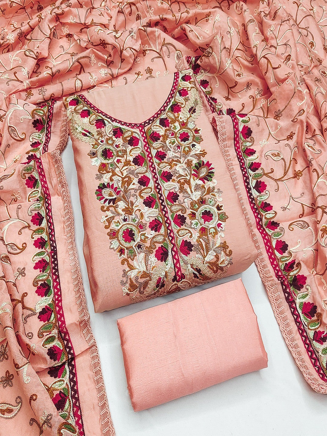 Ethnic Peach Roman Art Silk Dress Material Highlighted With Floral & Paisley Thread Embroidery - Image 1