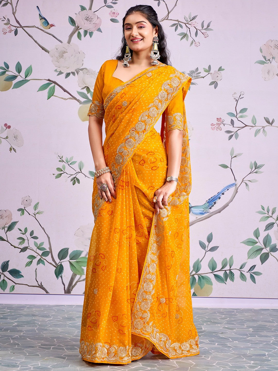 Graceful Mustard Bandhani Print Georgette Saree Highlighted With Floral Embroidery Work Border - Image 1