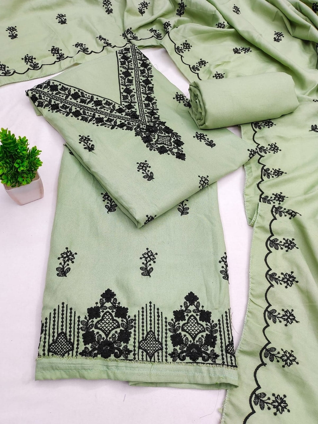 Peachmode Light Green Poly Rayon Unstitched Dress Material With Black Thread Embroidered V Neck And Daman Work And Embroidered Dupatta - Image 1