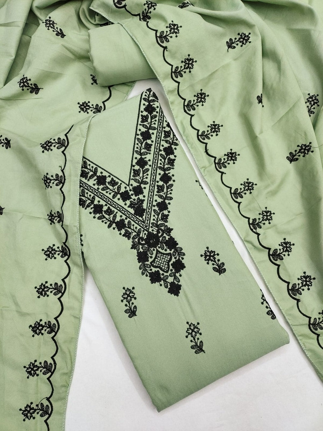 Peachmode Light Green Poly Rayon Unstitched Dress Material With Black Thread Embroidered V Neck And Daman Work And Embroidered Dupatta - Image 1