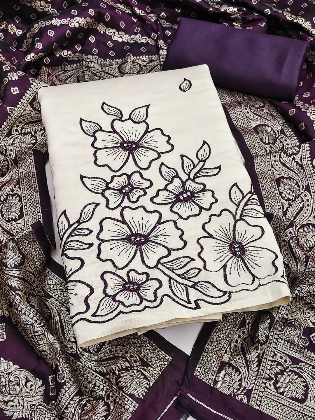 Peachmode Purple Roman Silk Unstitched Dress Material With Multi Sequence Floral Embroidery And Banarasi Silk Jacquard Dupatta - Image 1