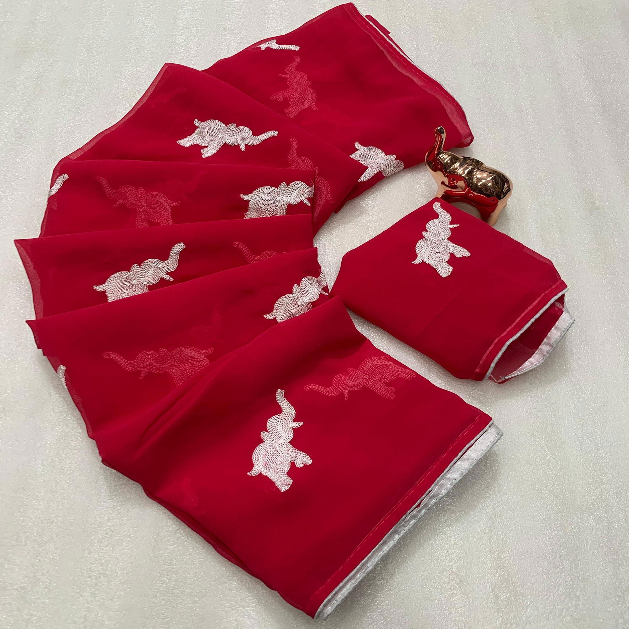 Pink Georgette Saree Featuring Exquisite Elephant Embroidery