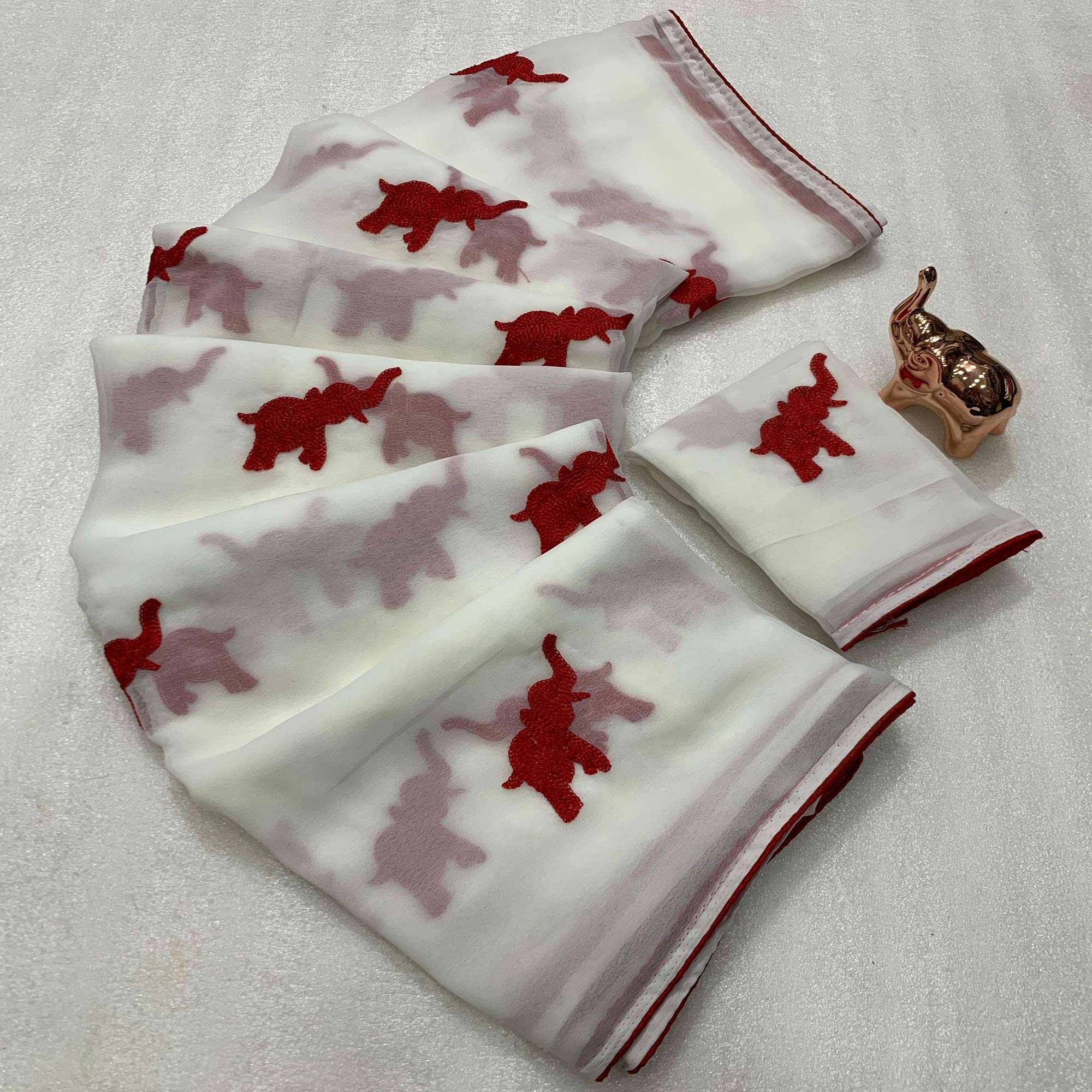 White Georgette Saree Featuring Exquisite Elephant Embroidery