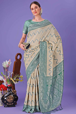 Cream Lichi Cotton Silk Saree Adorned With Floral Zari Weave & Tassels