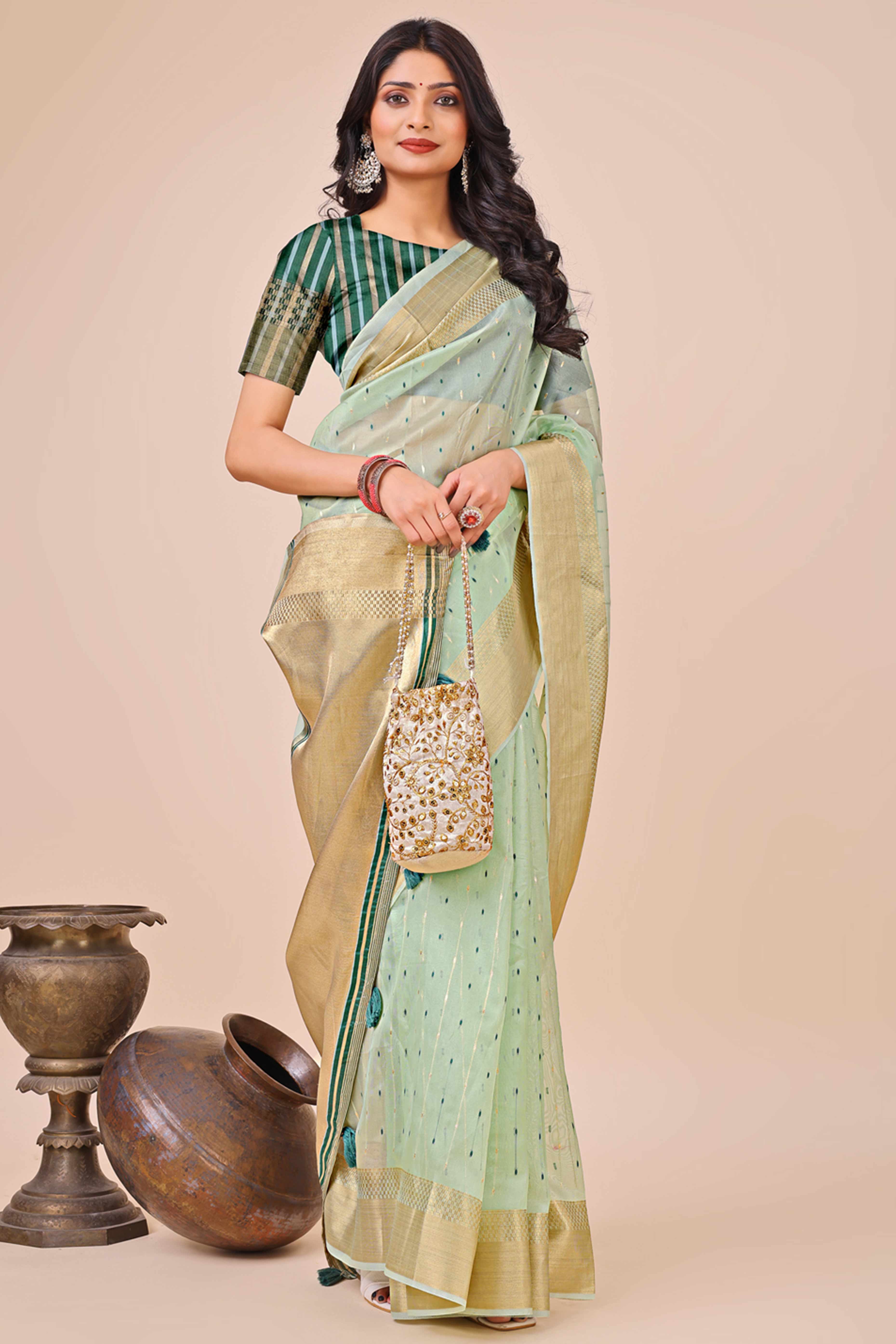 Sea Green Organza Saree Adorned With Fine Zari Weaving & Stylish Tassel Edging