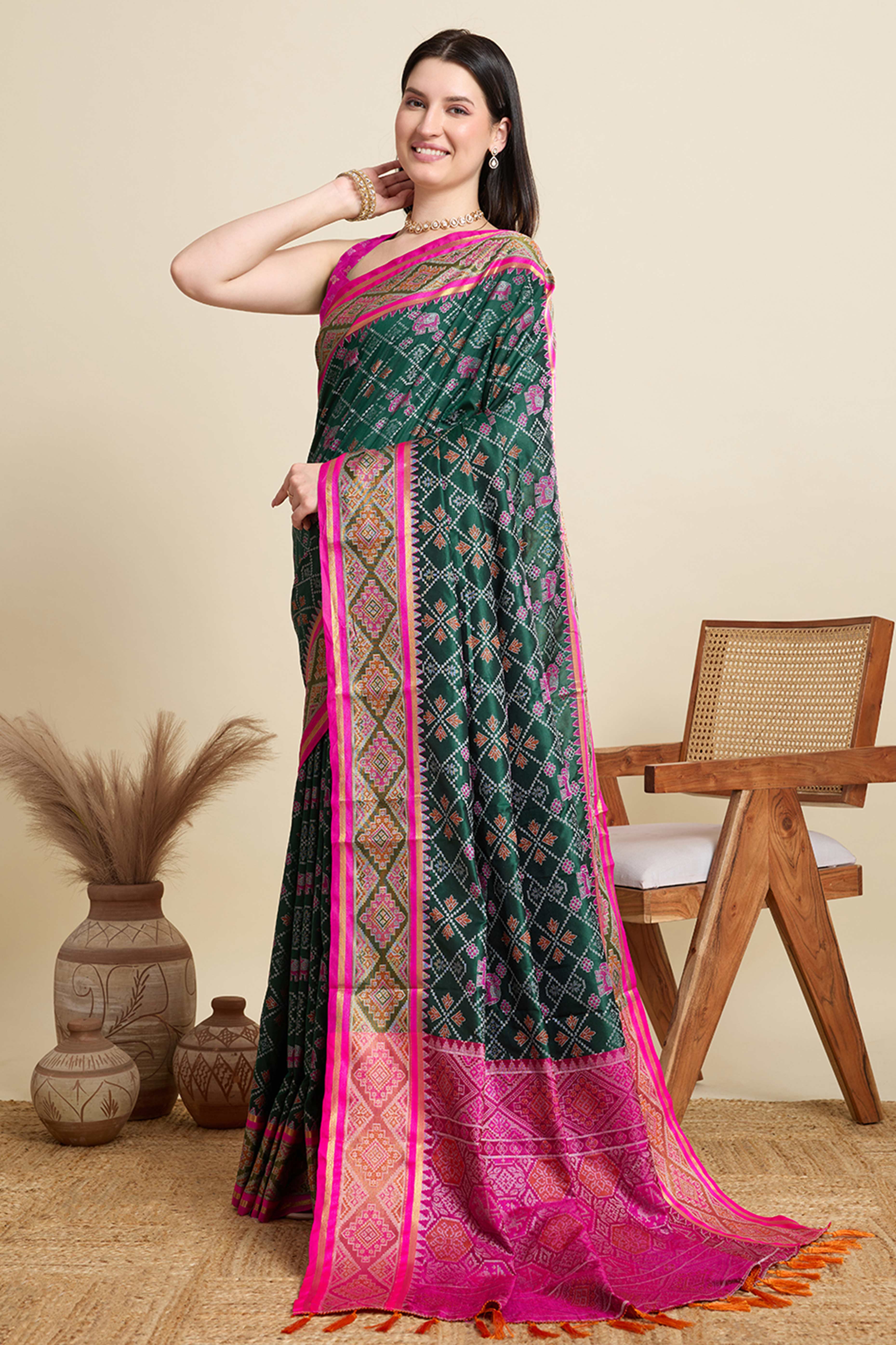 Green Silk Blend Saree Featuring Patola Prints and a Detailed Weaving Border