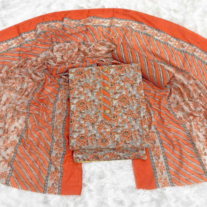 Charming Orange Floral Printed Cotton Blend Dress Material Featuring Intricate Lace Border