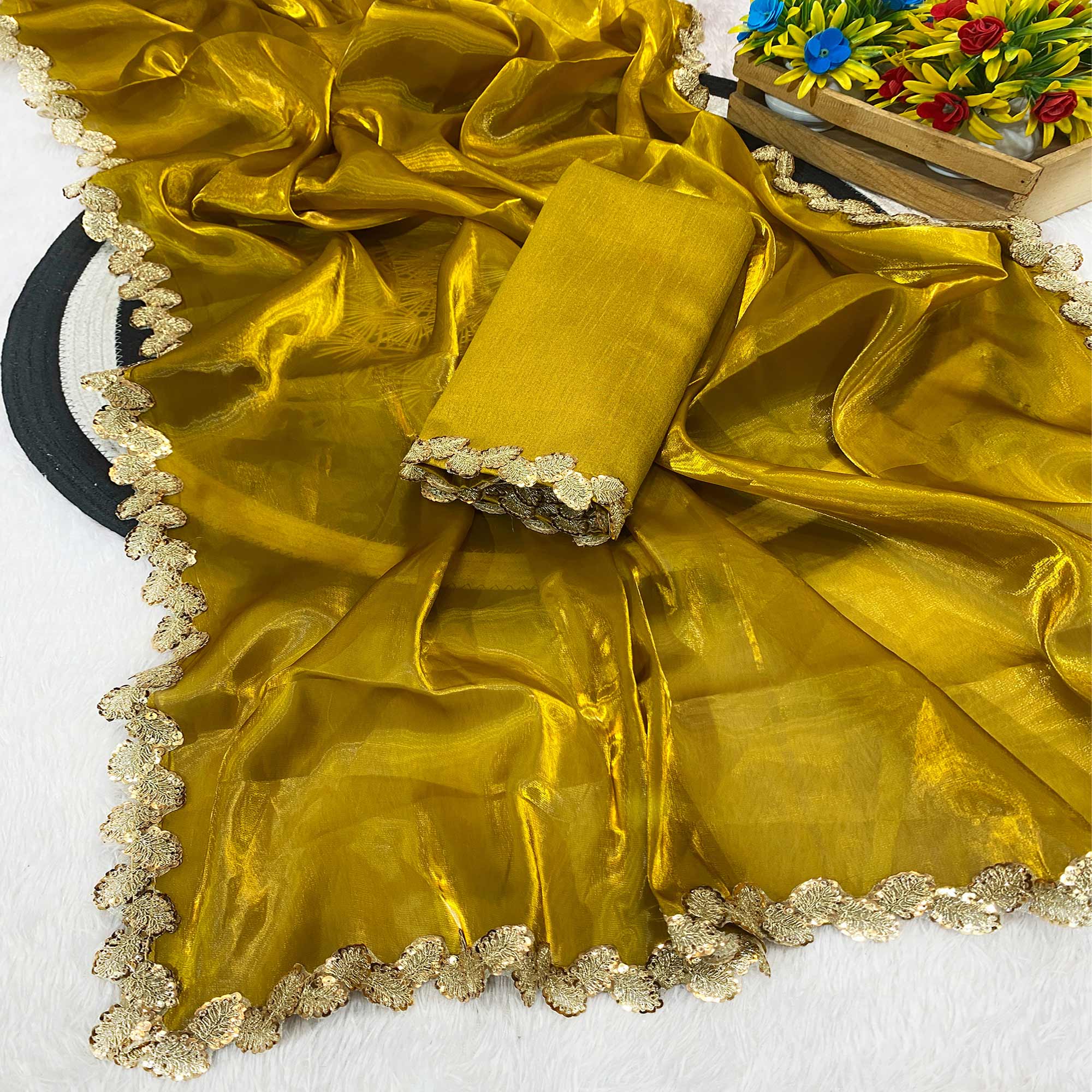 Gold Tissue Saree Featuring Solid Finish and Delicate Lace Work by Jimmy Choo Style