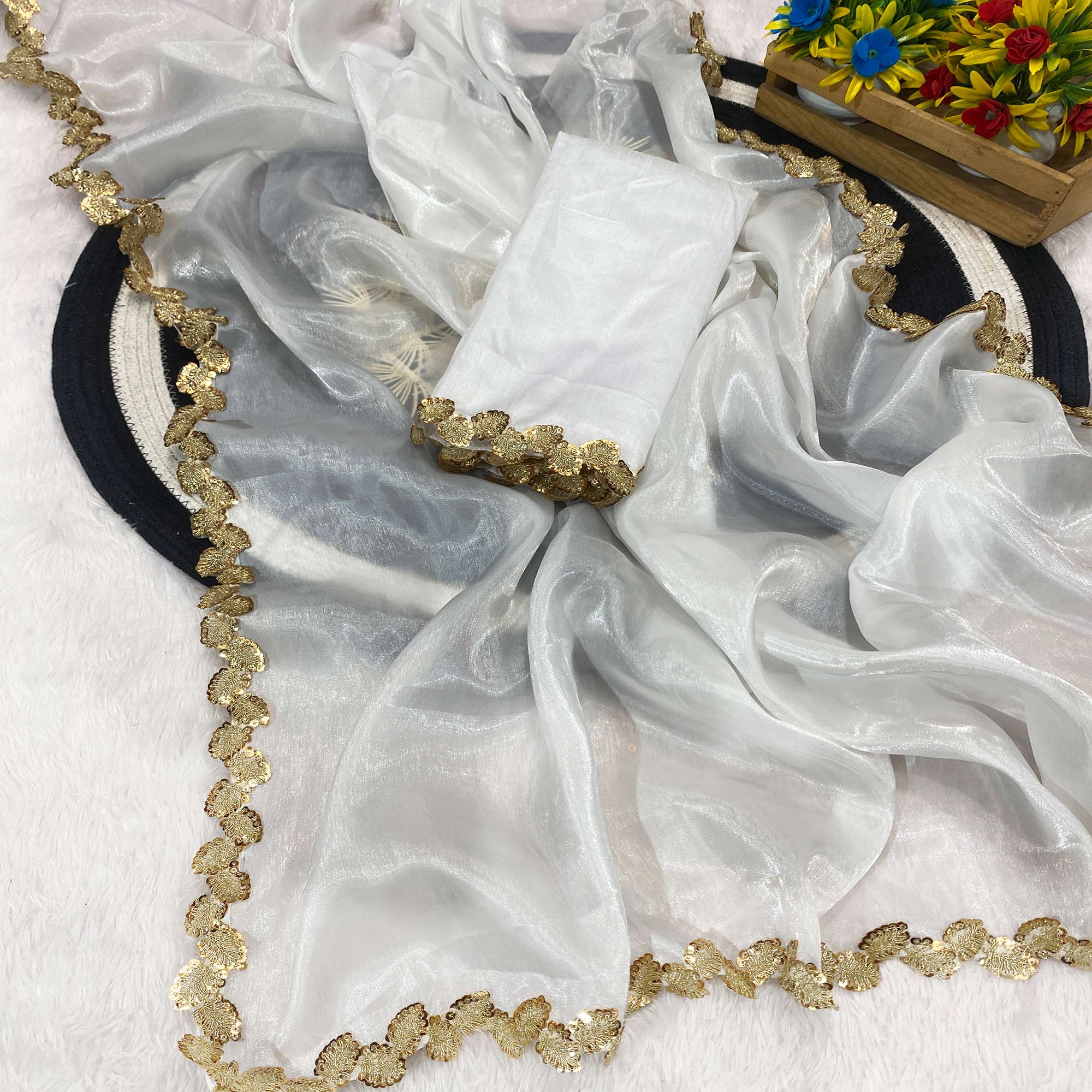 White Tissue Saree Featuring Solid Finish and Delicate Lace Work by Jimmy Choo Style