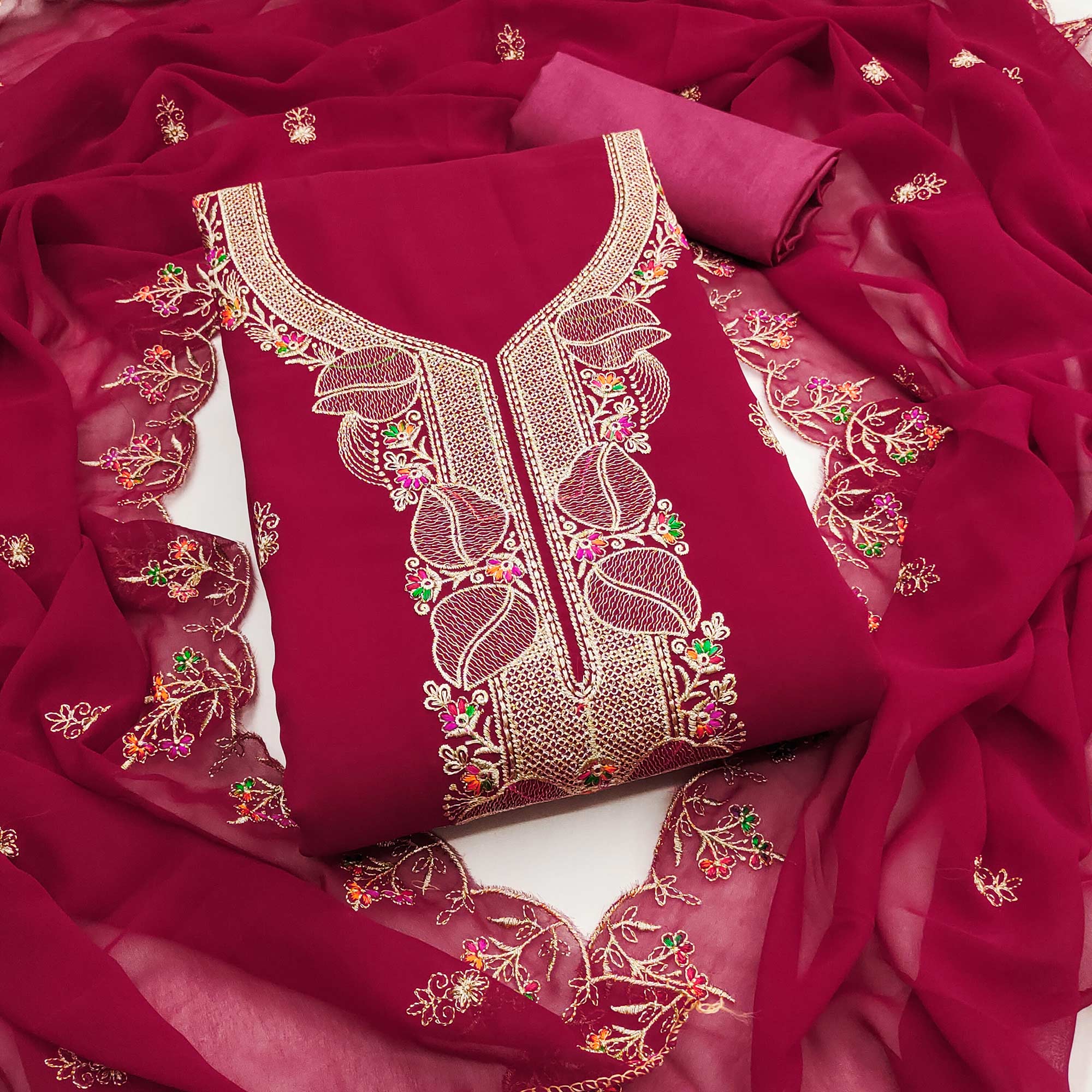 Rani Pink Georgette Dress Material Adorned With Floral Embroidery & Elegant Lace Border