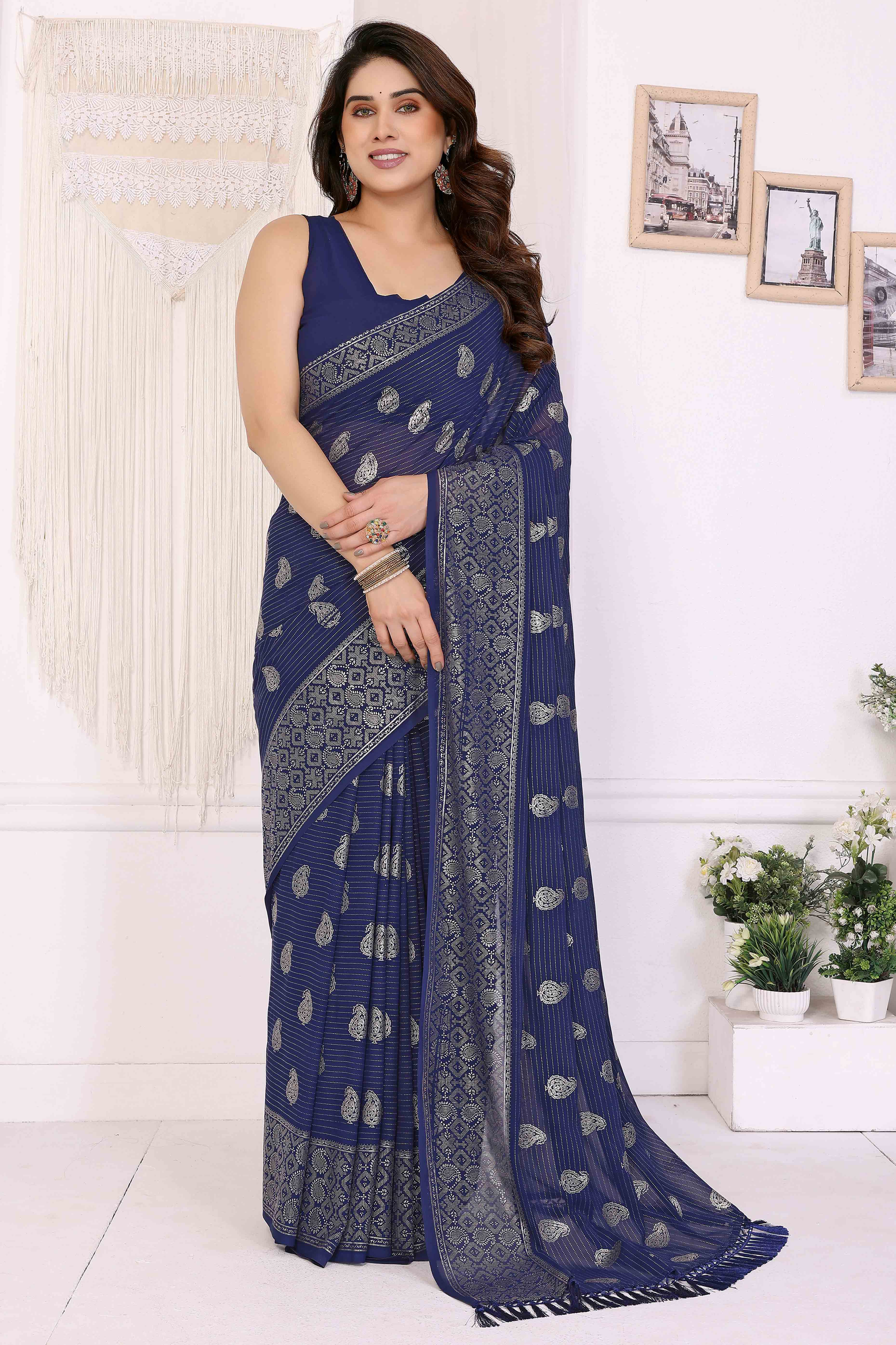 Blue Foil Printed Georgette Saree Enhanced With Delicate Lace Border & Elegant Tassel