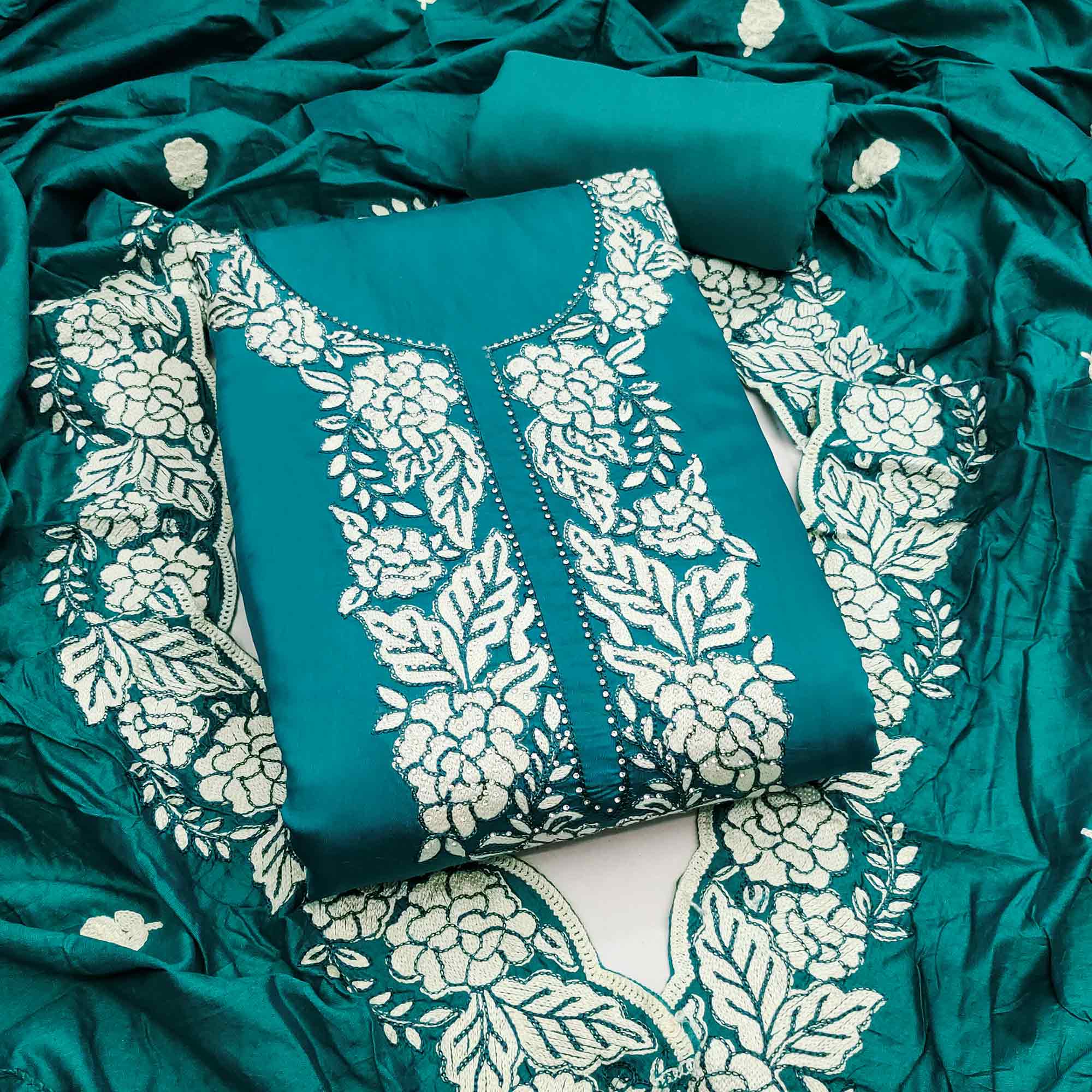 Teal Green Rich Viscose Dress Material Highlighted with Refined Floral Thread Embroidery
