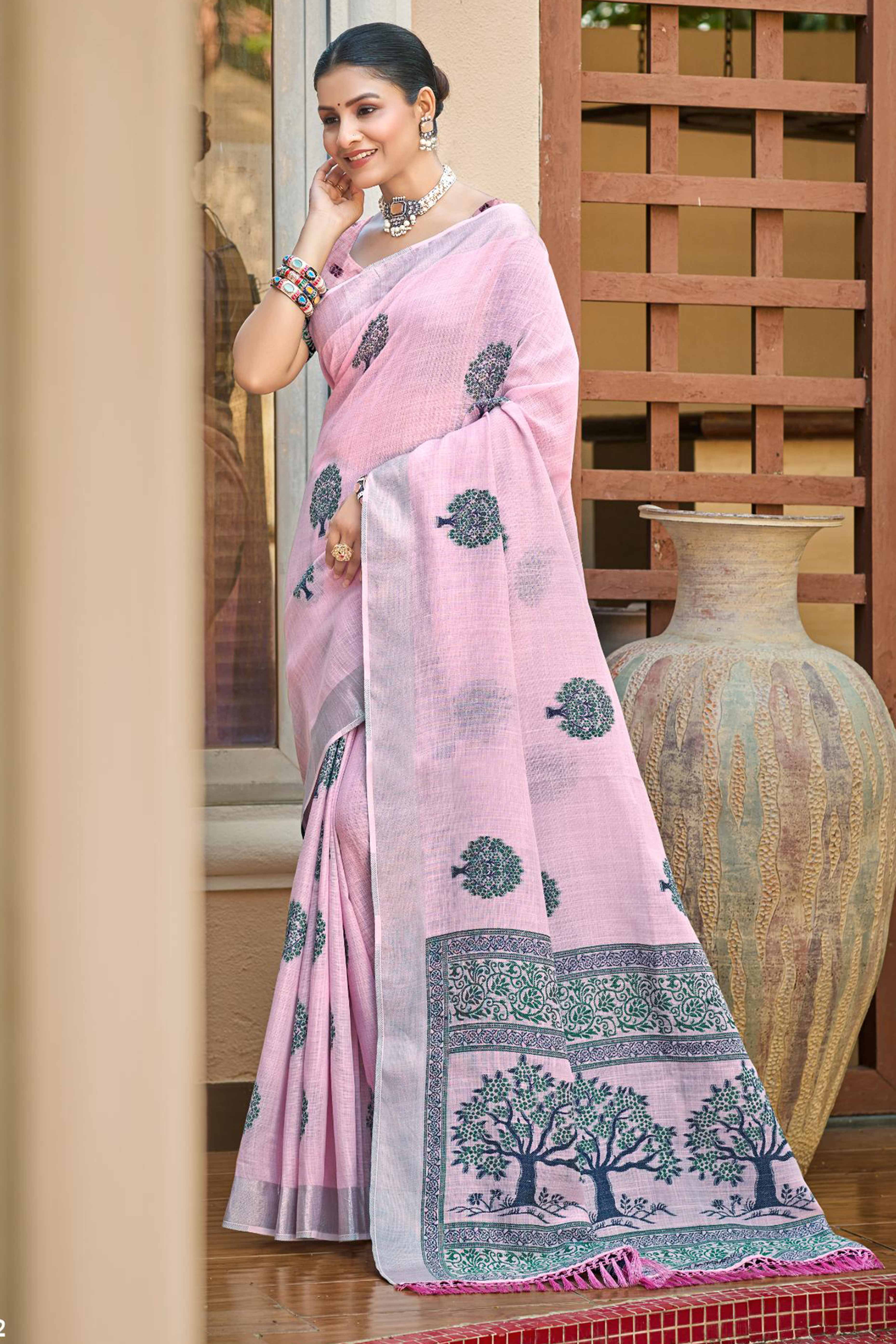 Light Pink Linen Saree Adorned With Intricate Zari Weaving & Tassel Pallu