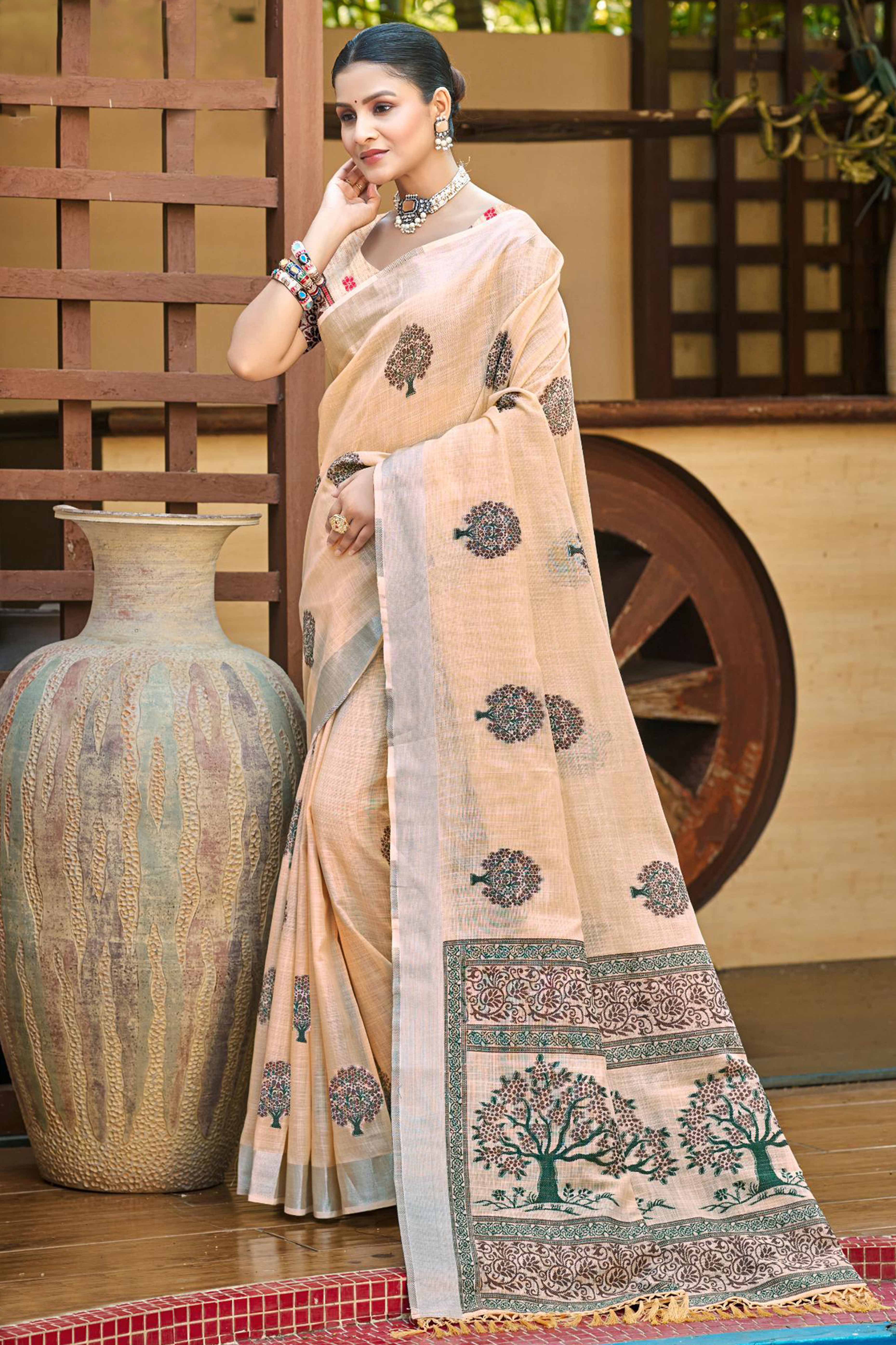 Peach Linen Saree Adorned With Intricate Zari Weaving & Tassel Pallu