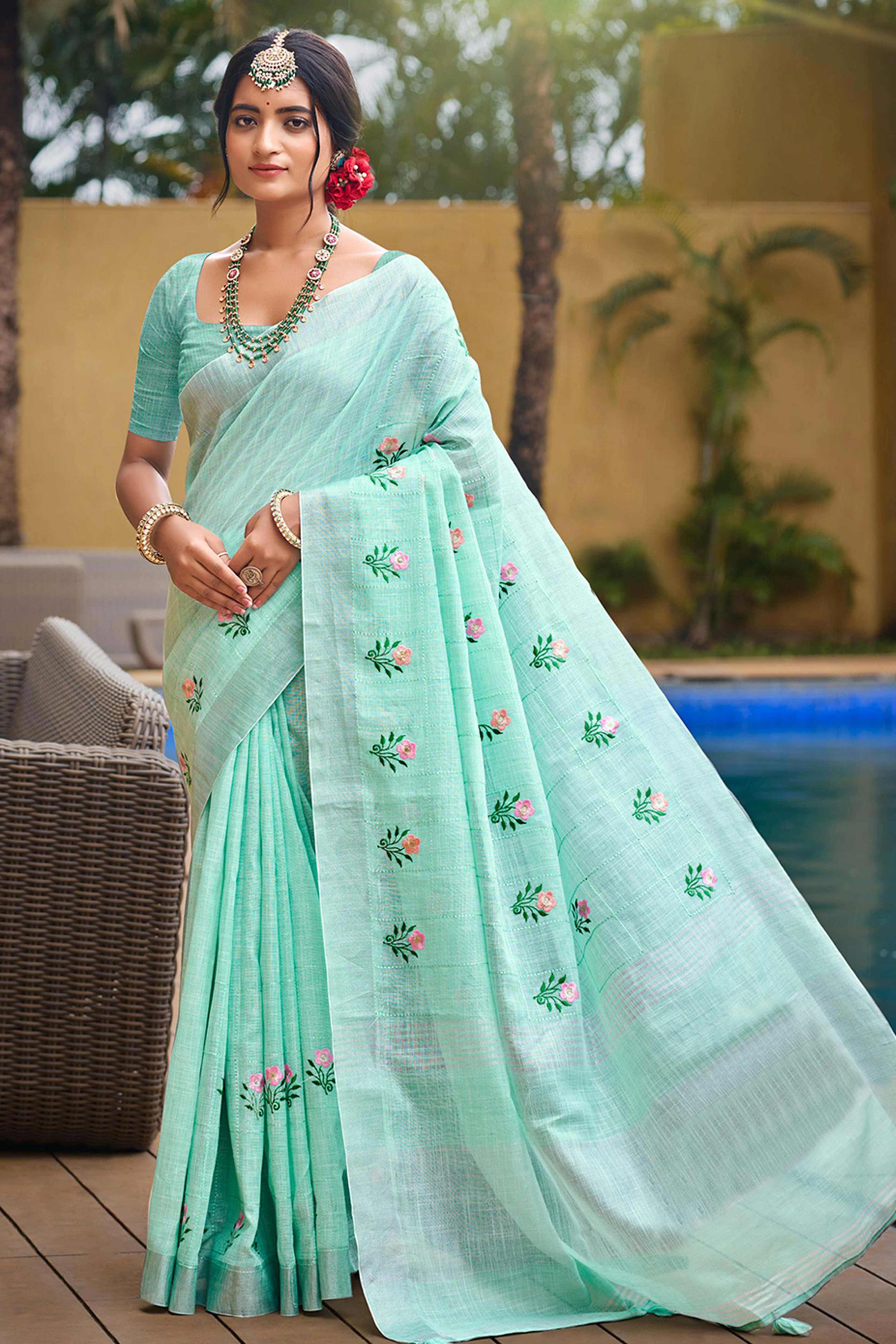 Captivating Turquoise Floral Thread Embroidered Linen Saree With Elegant Weaving Border