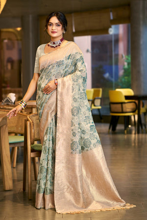 Teal Premium Cotton Silk Saree Highlighted With Floral Weaving Work & Tassel Pallu