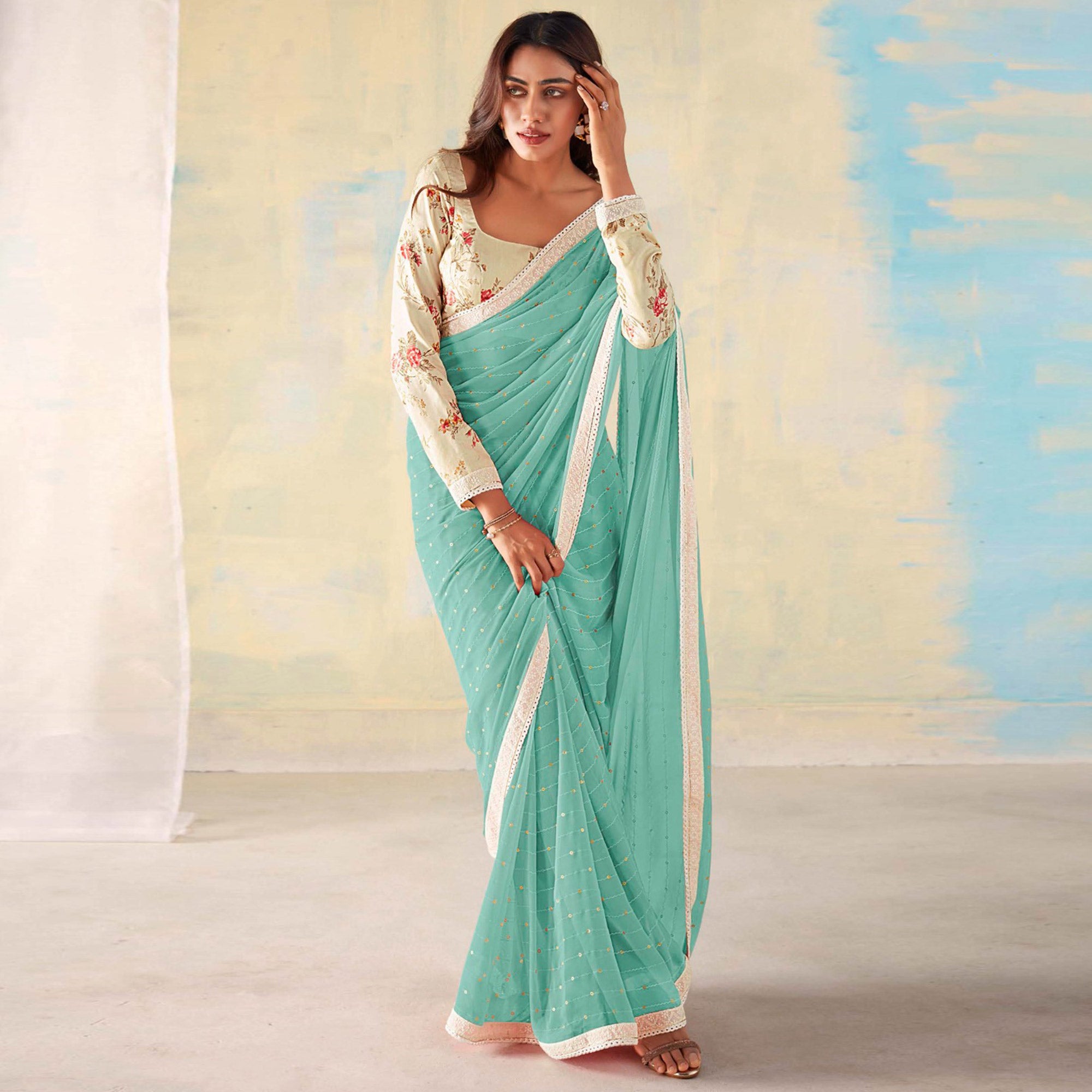 Aqua Blue Foil Printed Georgette Saree With Embroidered Border