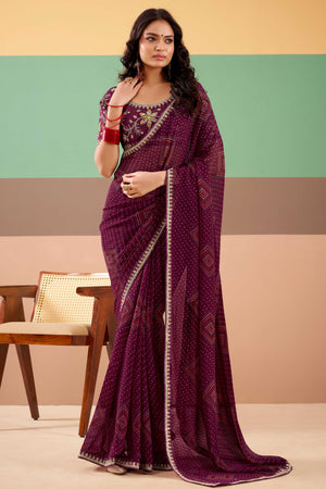 Charming Wine Bandhani Printed Georgette Saree Adorned With Intricate Cording Embroidered Border