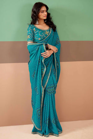 Charming Blue Bandhani Printed Georgette Saree Adorned With Intricate Cording Embroidered Border
