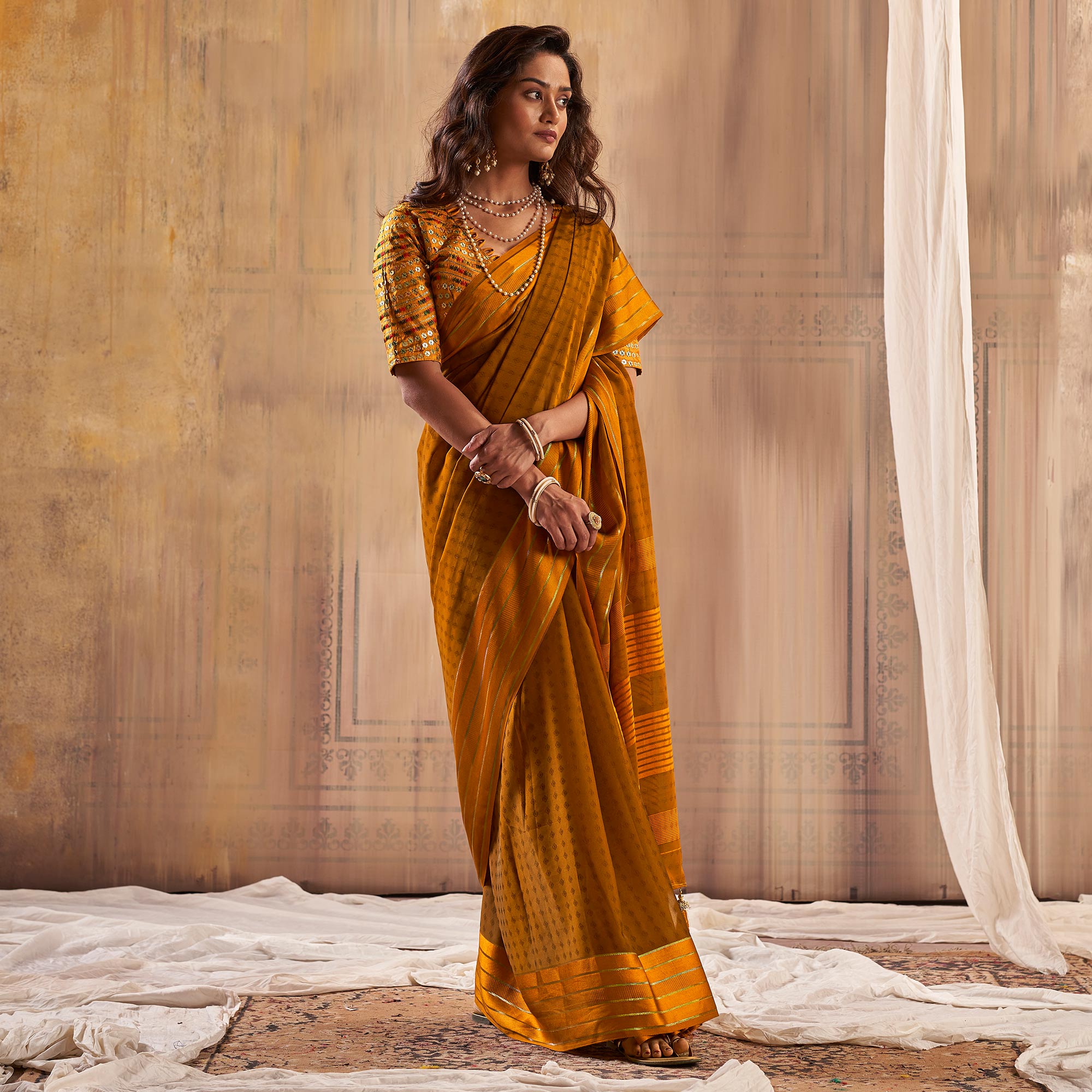 Mustard Woven Georgette Saree With Tassels