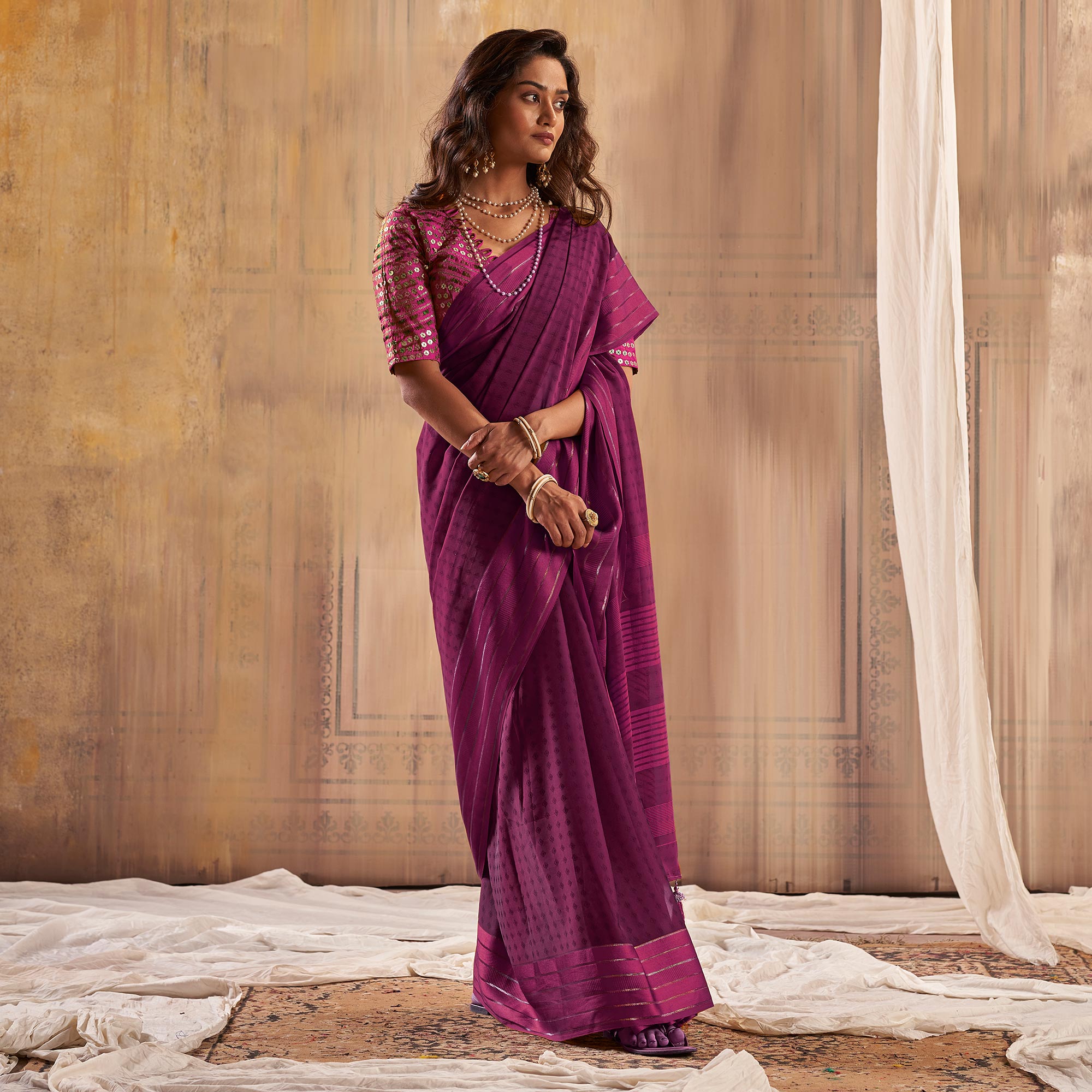 Purple Woven Georgette Saree With Tassels