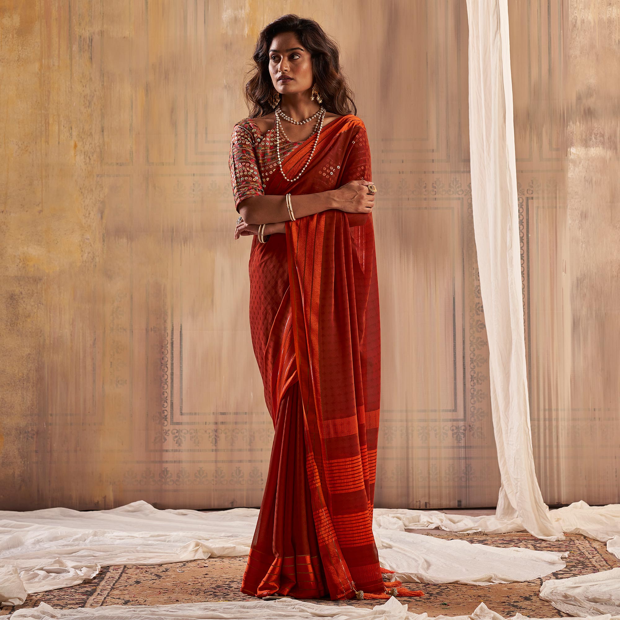 Rust Woven Georgette Saree With Tassels