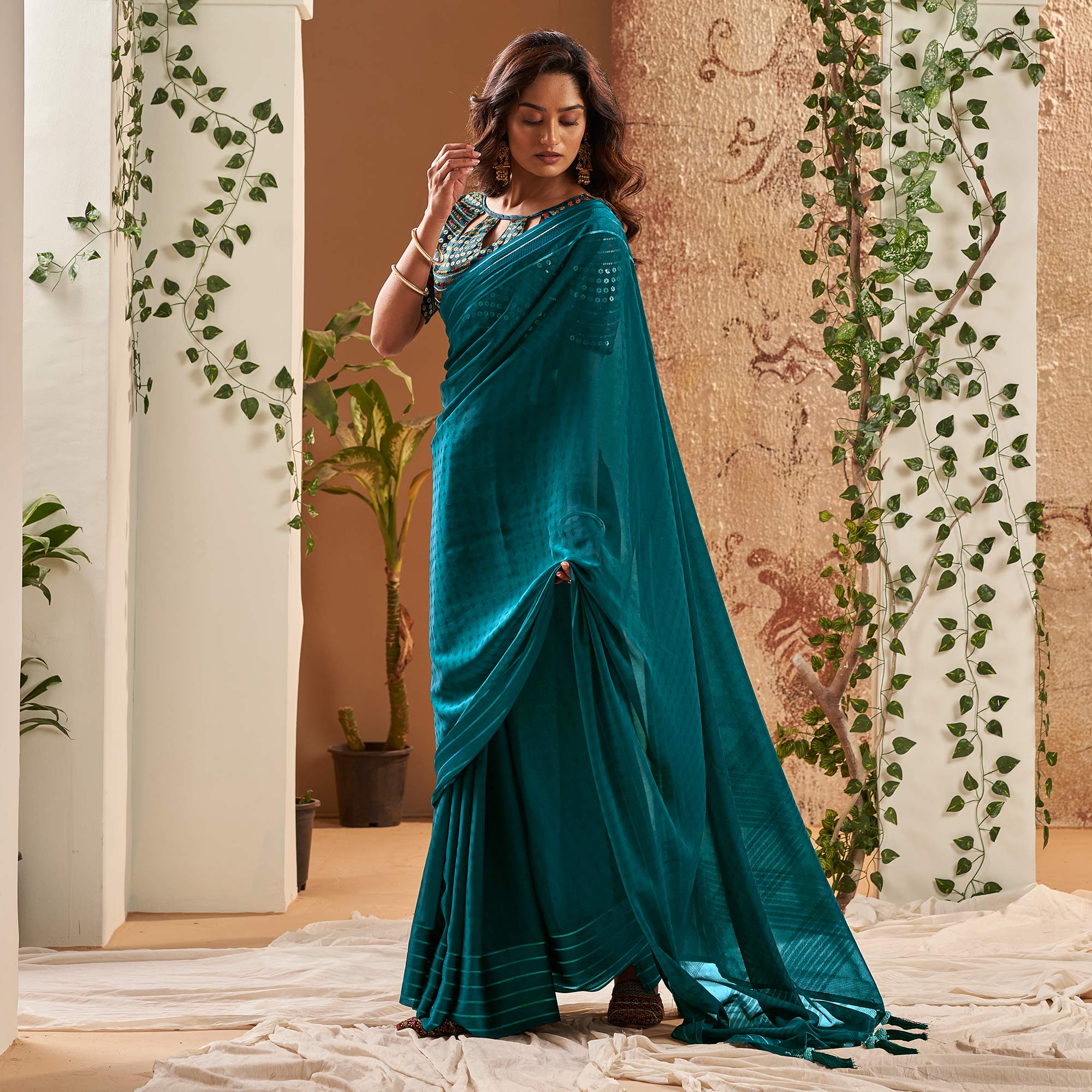 Teal Woven Georgette Saree With Tassels