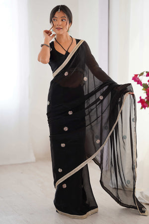 Elegant Black Organza Saree with Delicate Floral Embellishments and Lace Border