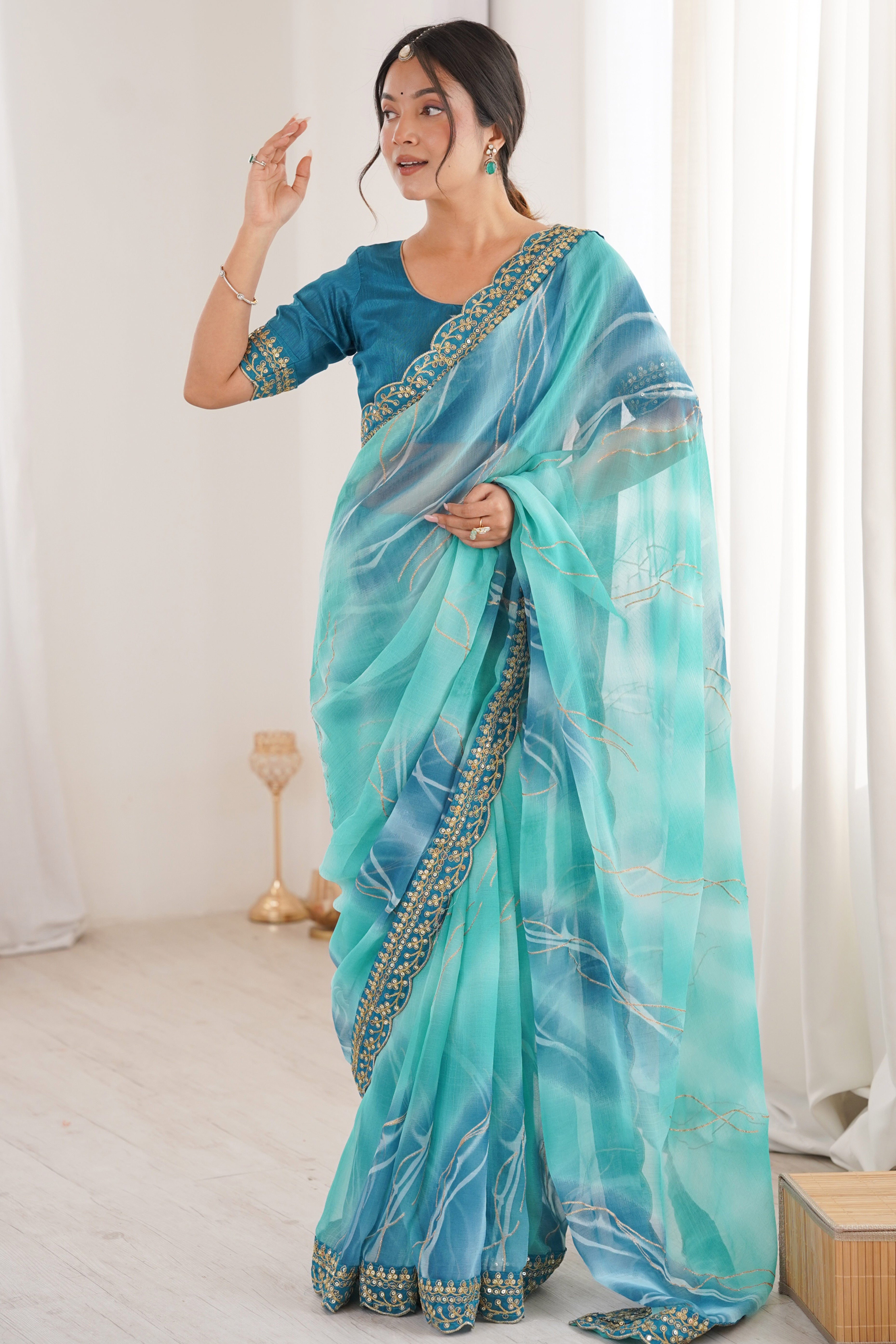 Graceful Blue Foil Print Georgette Saree Featuring A Luxurious Cording Sequins Embroidered Border