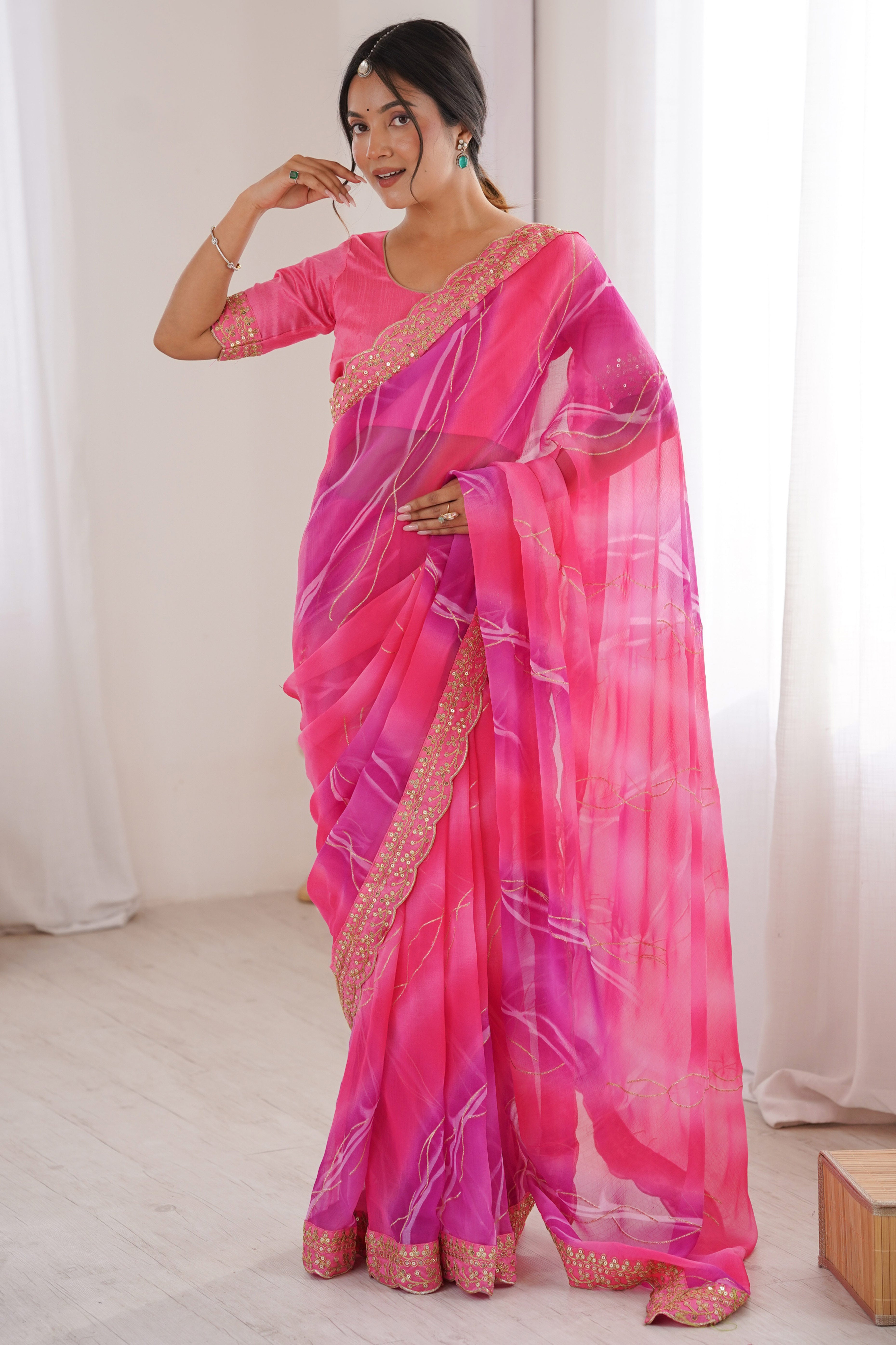 Graceful Pink Foil Print Georgette Saree Featuring A Luxurious Cording Sequins Embroidered Border