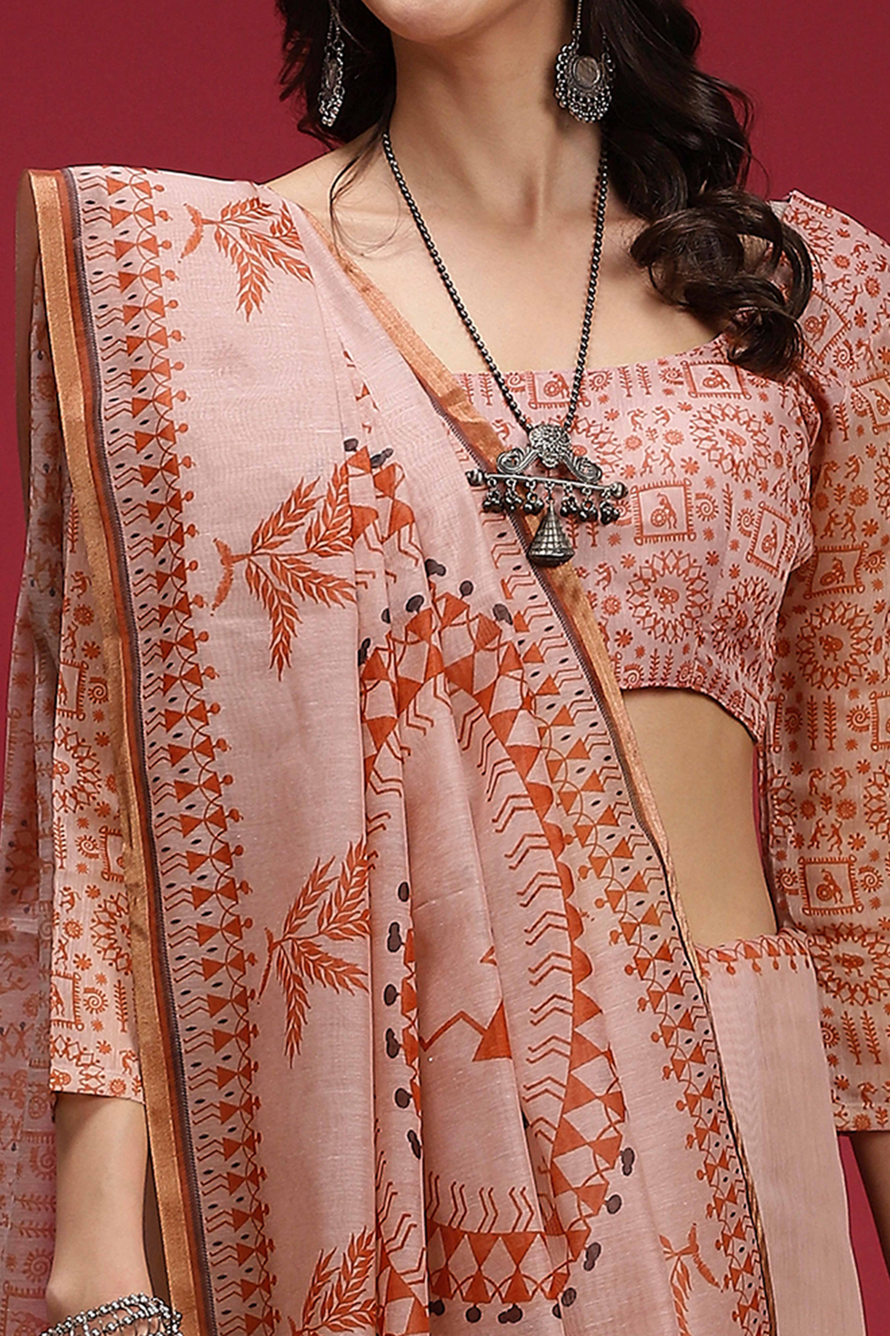 Light Peach Linen Cotton Saree Featuring Traditional Warli Prints & Tassel Pallu