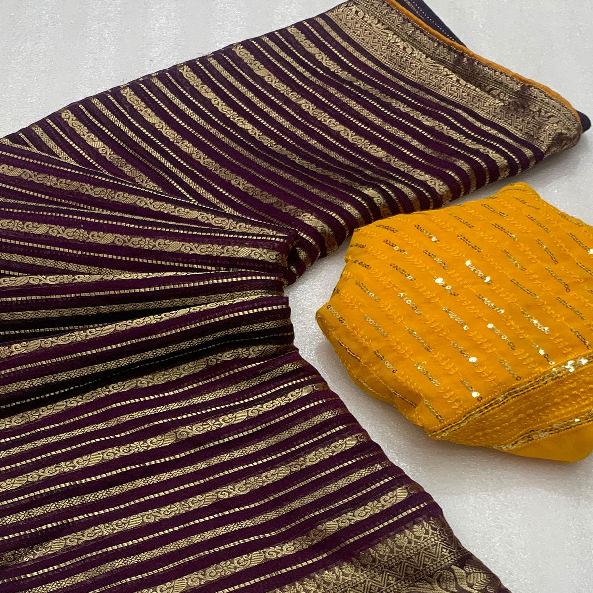 Wine Woven Georgette Saree With Tassels