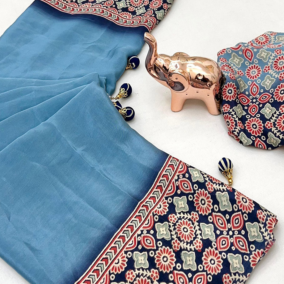 Blue Solid Satin Saree Featuring Bold Ajrakh Print and Tassel Accented Pallu