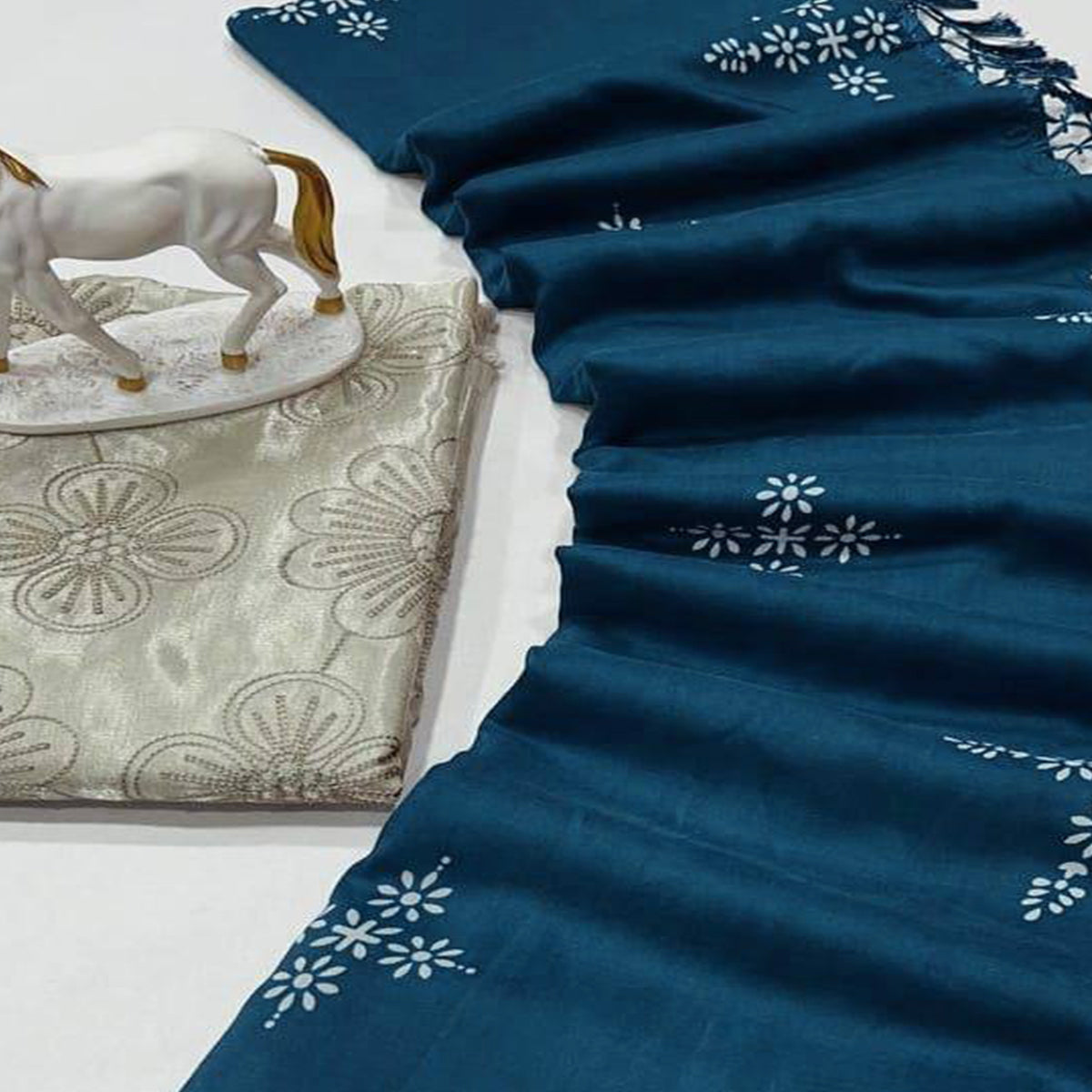 Peacock Blue Muslin Cotton Silk Saree Adorned With Delicate Floral Prints & Playful Tassels