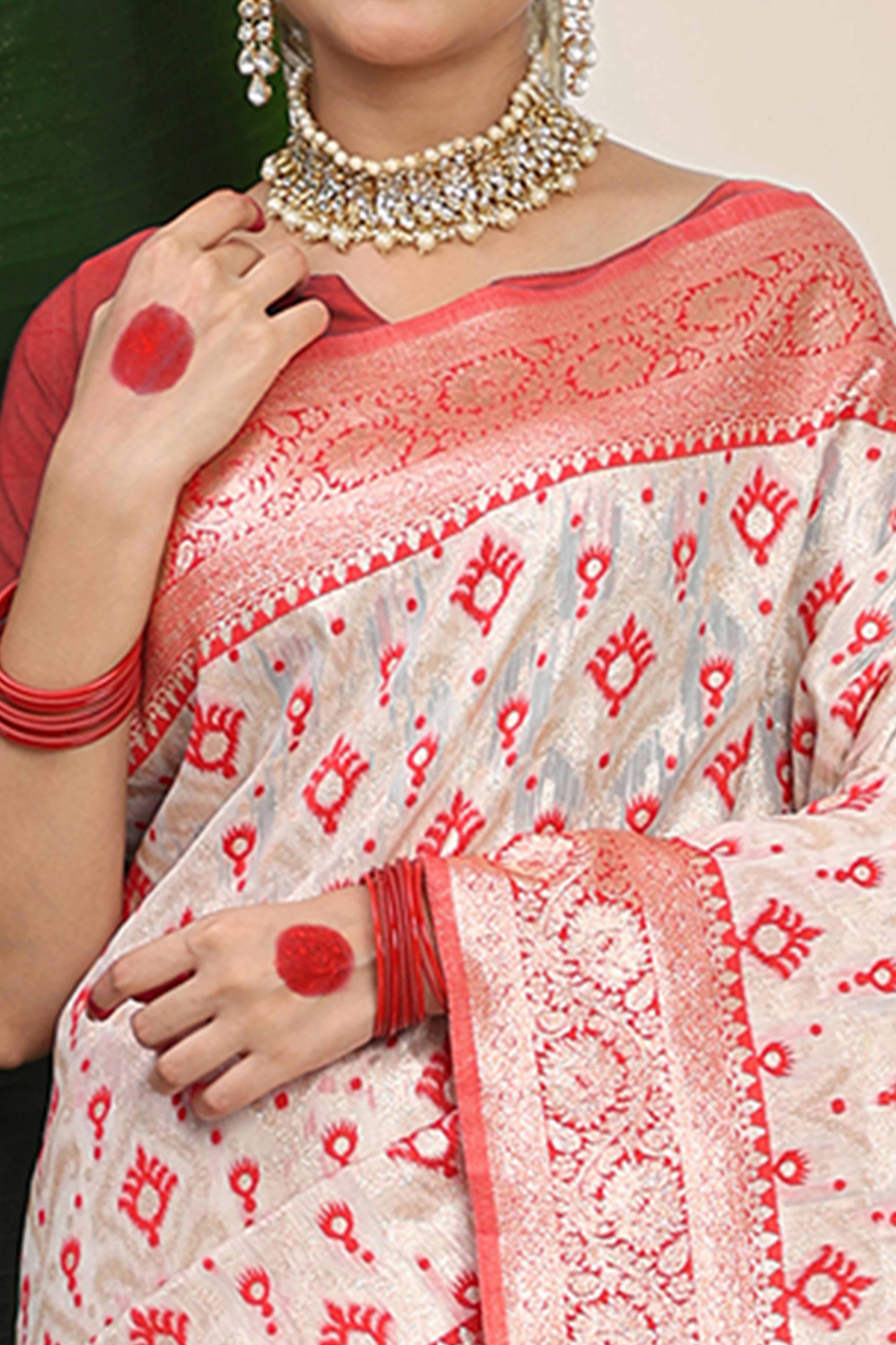 White & Red Linen Cotton Saree Accented With Rich Zari Weaving And A Decorative Tassel Pallu