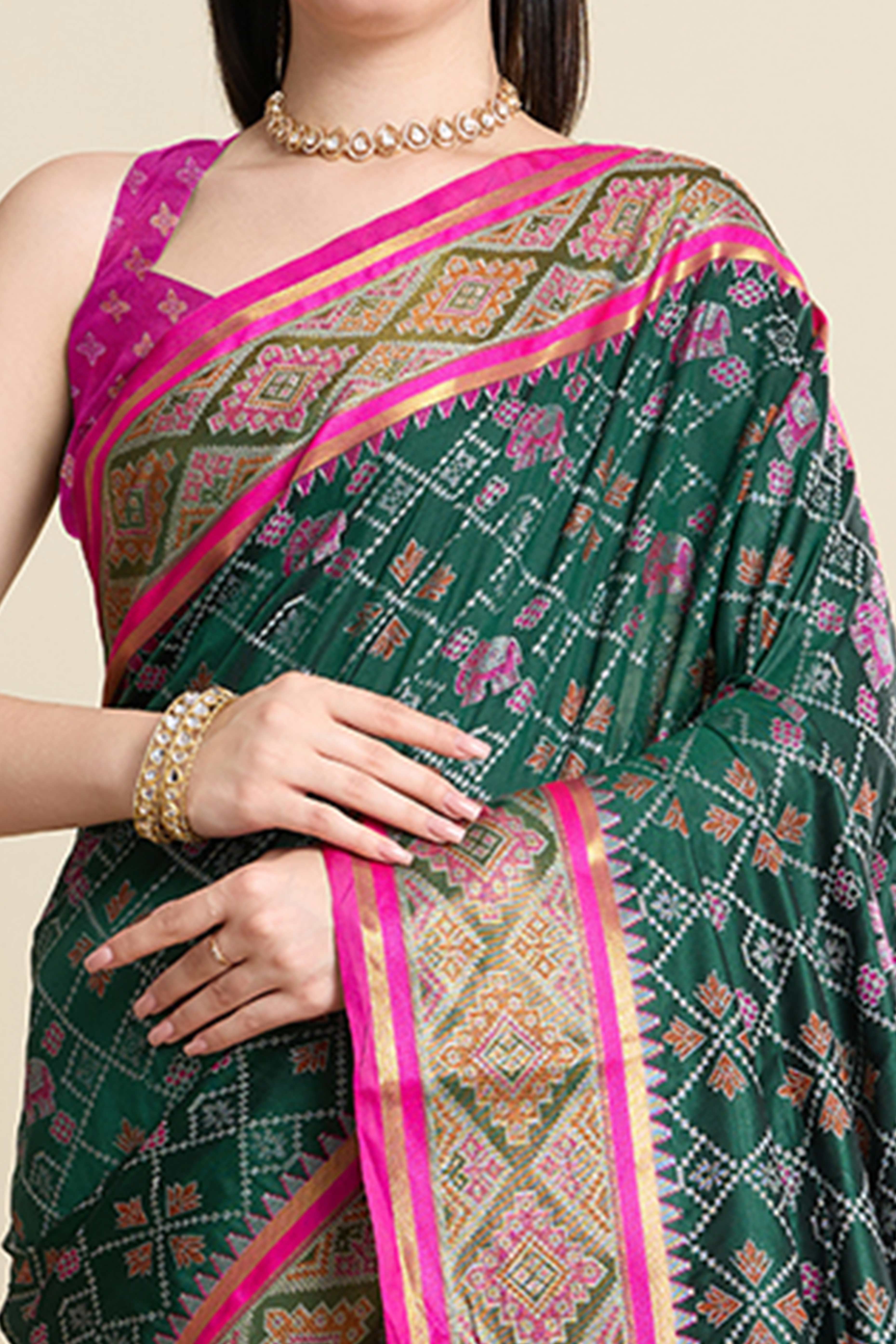 Green Silk Blend Saree Featuring Patola Prints and a Detailed Weaving Border