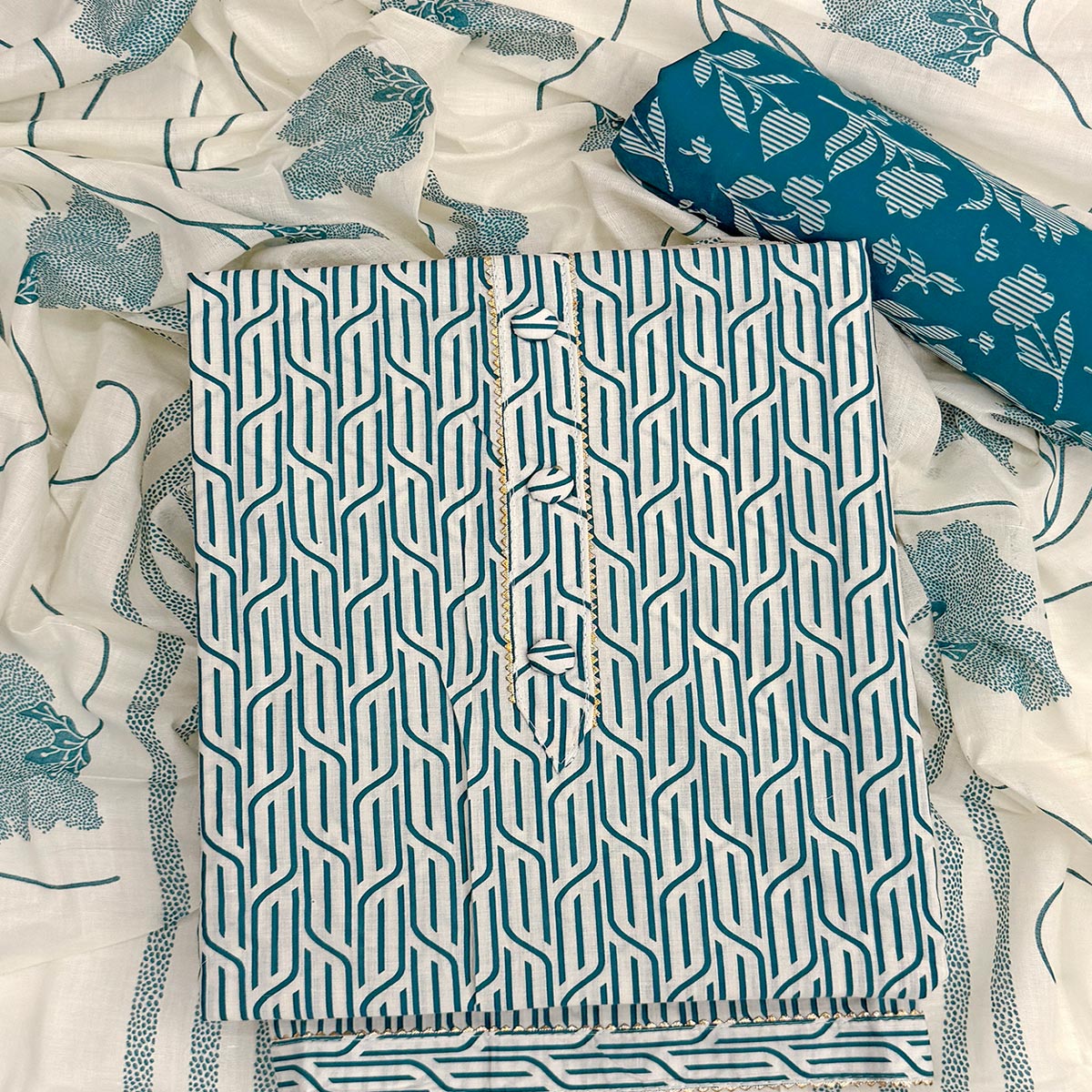 Trendy Teal Geometric Print Pure Cotton Dress Material Featuring Stylish Tie Neck & Fancy Button