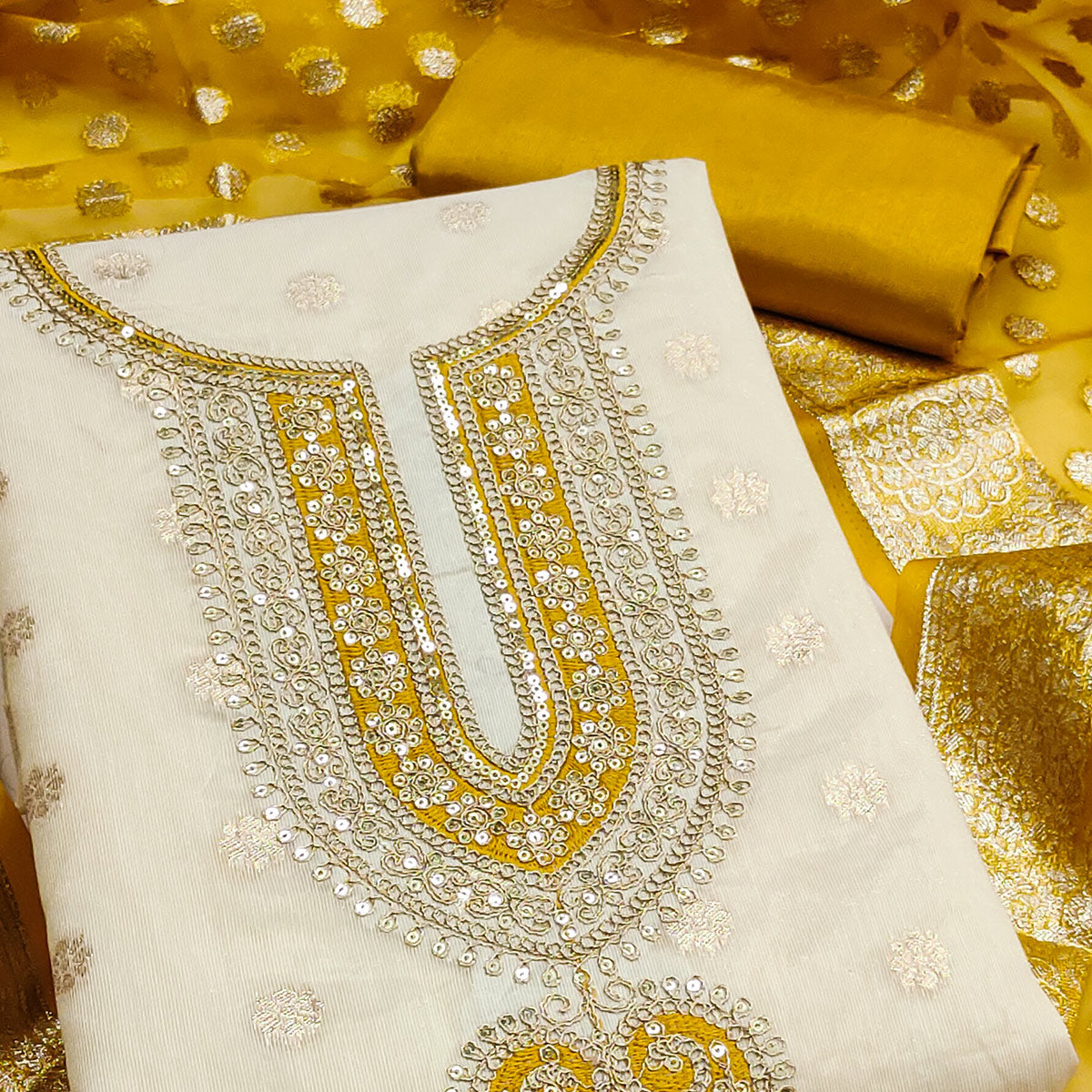 Graceful Cream & Mustard Butti Weaving Shimmer Dress Material Adorned With Cording Embroidery Work