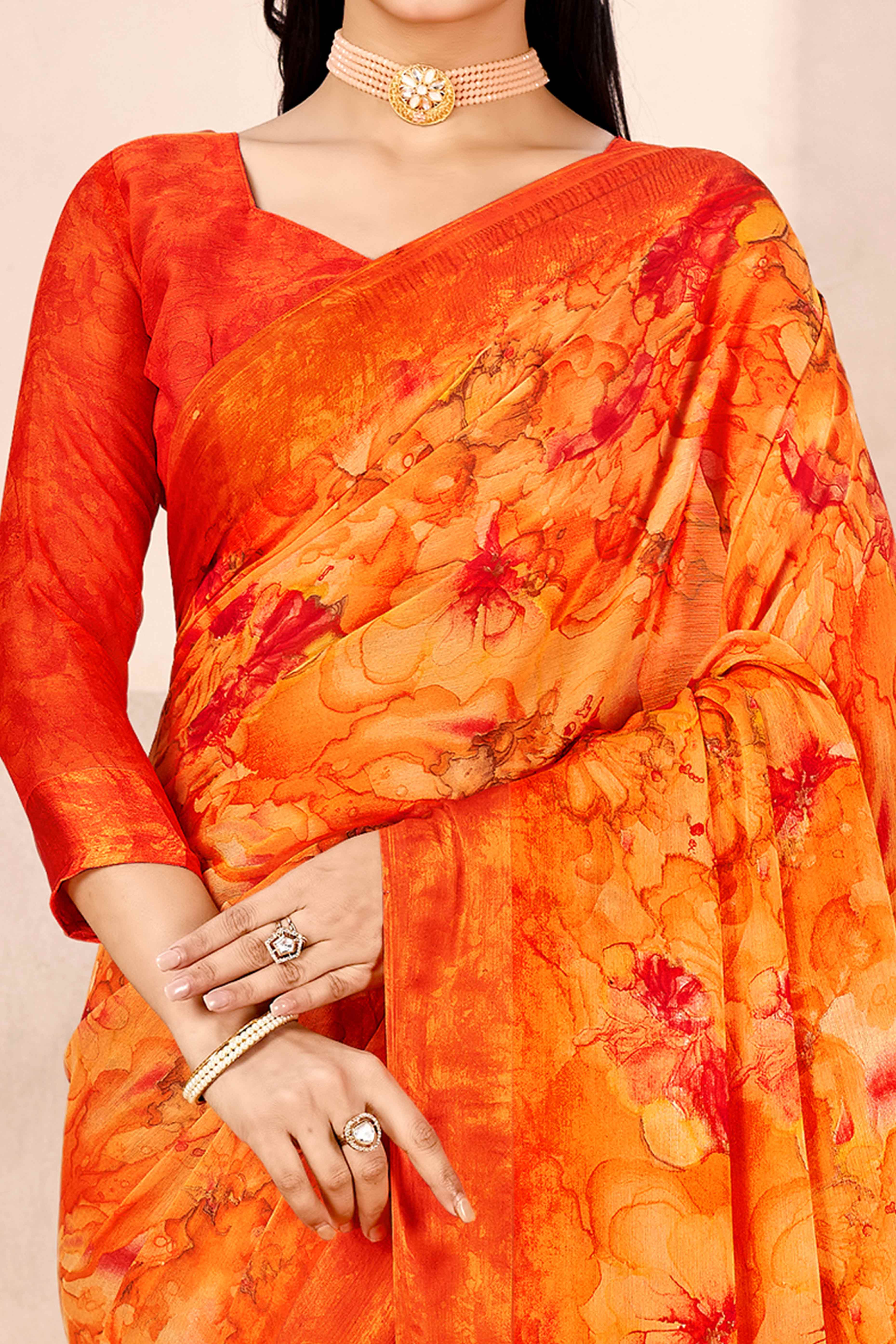 Orange Chiffon Saree With Delicate Floral Prints & Elegant Woven Border