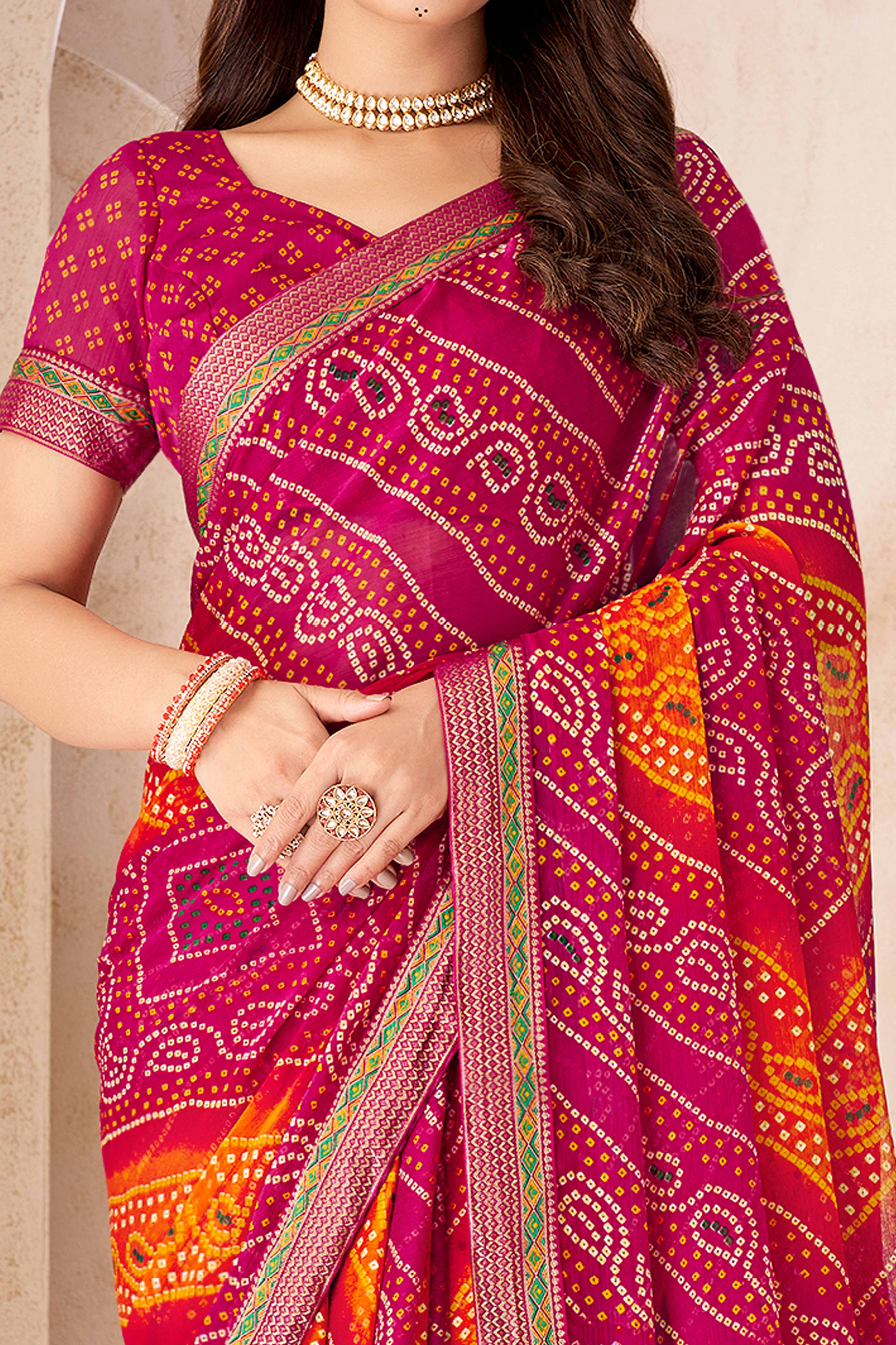 Magenta & Orange Bandhani Printed Chiffon Saree Enhanced with Delicate Lace Border Work