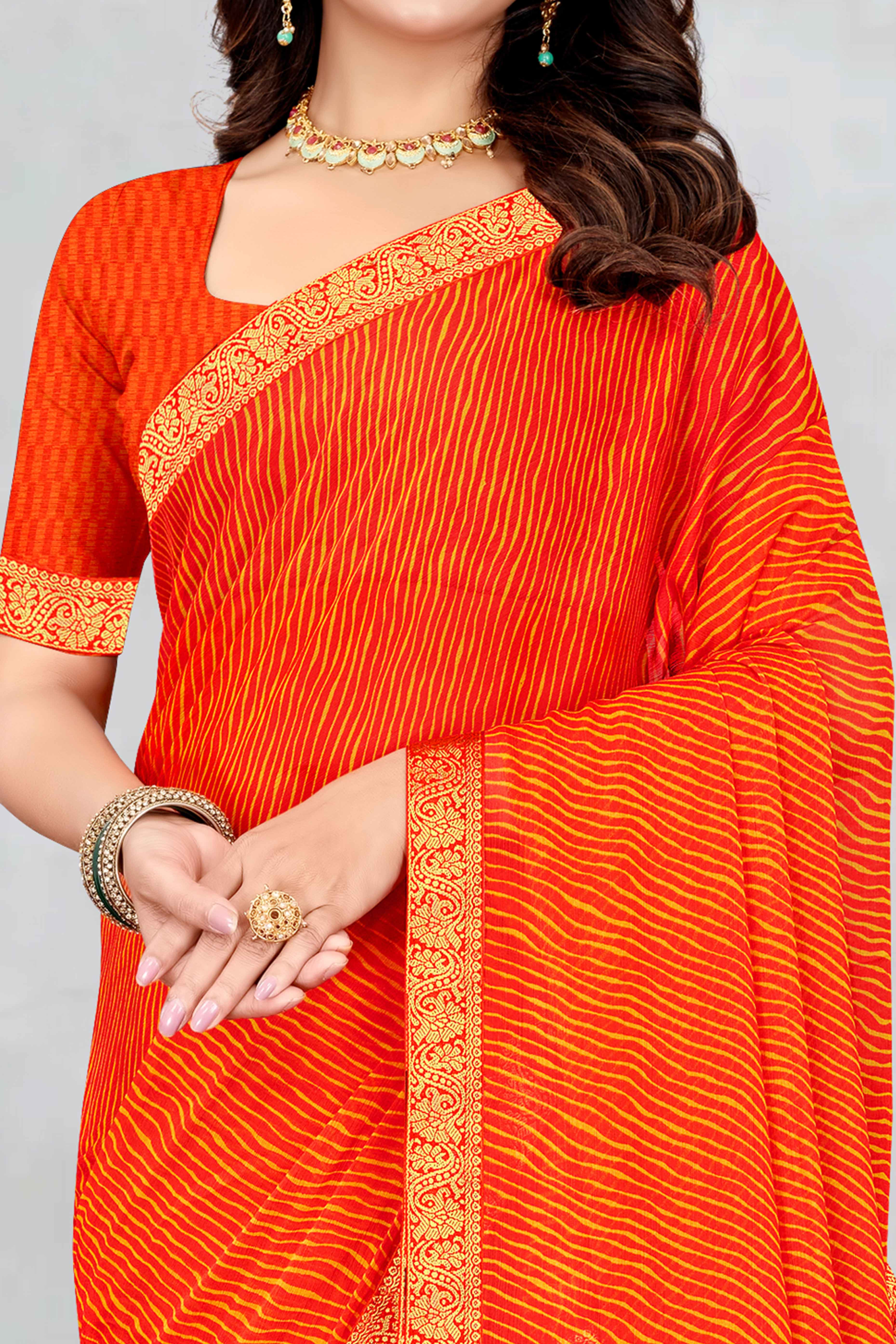 Orange Leheriya Printed Chiffon Saree Accented With A Graceful Floral Weaving Lace Border