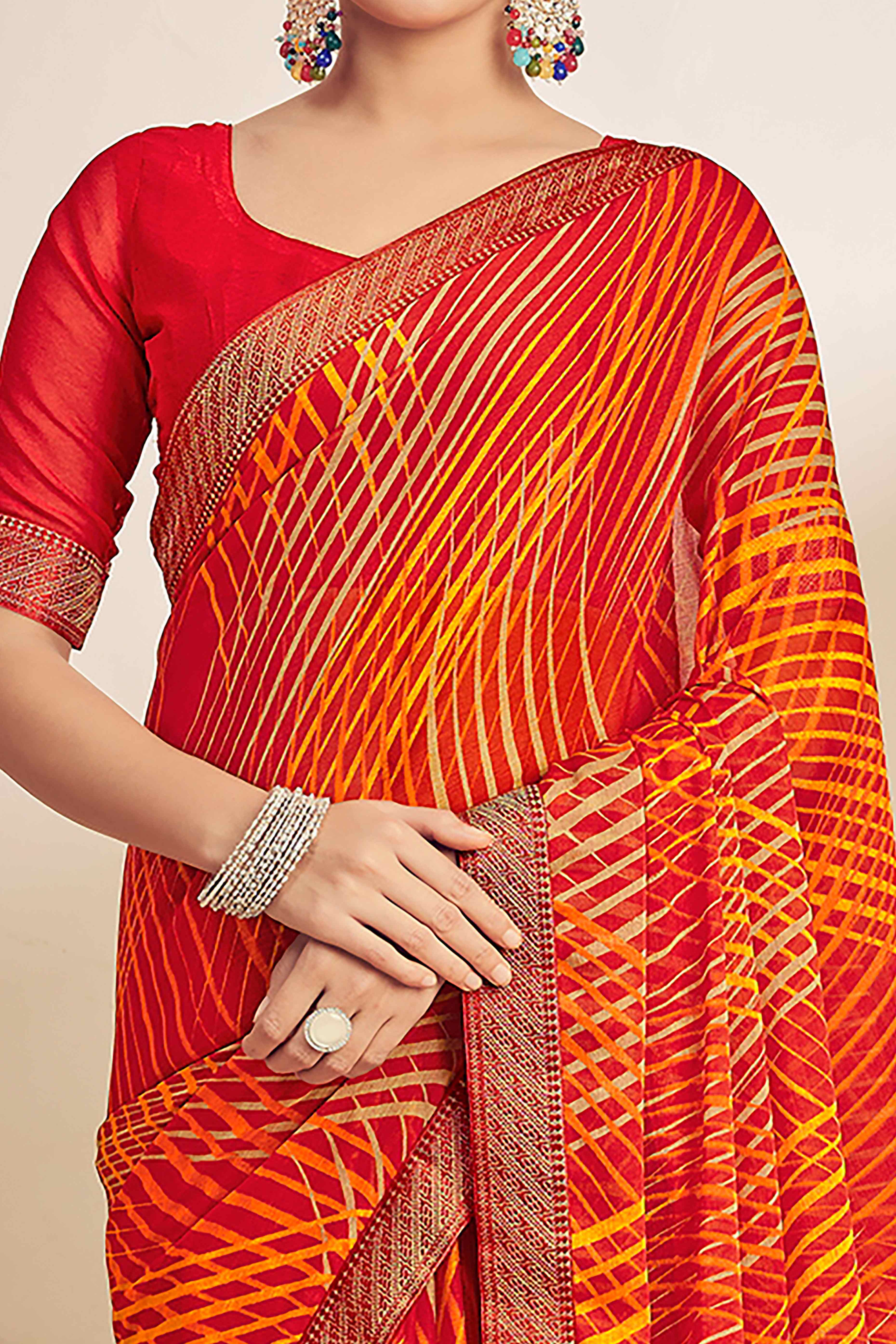 Orange Chiffon Saree Adorned With Artistic Print & Finely Crafted Woven Lace Border