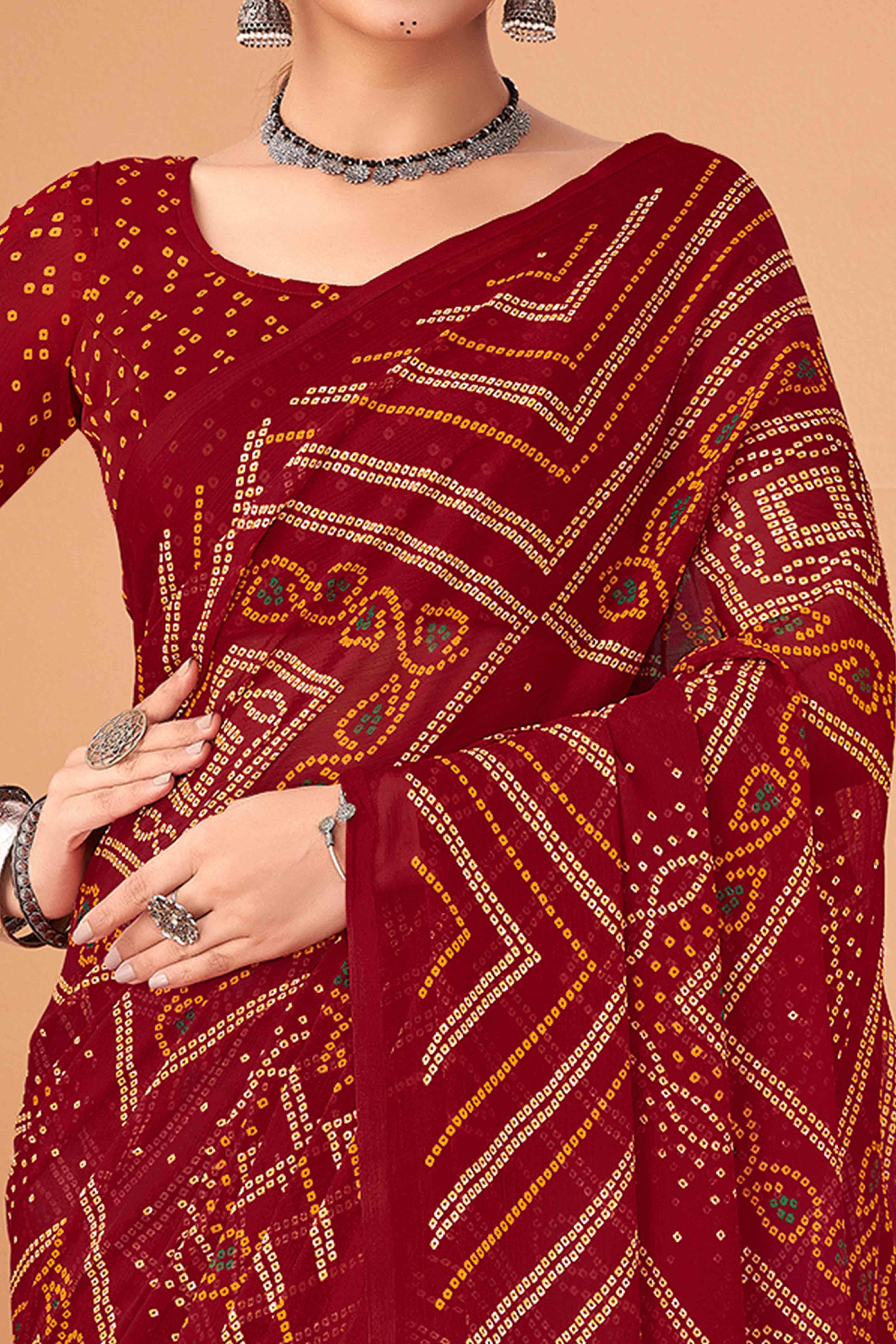 Maroon Bandhani Printed Chiffon Saree Accented With Intricate Lace Border Work