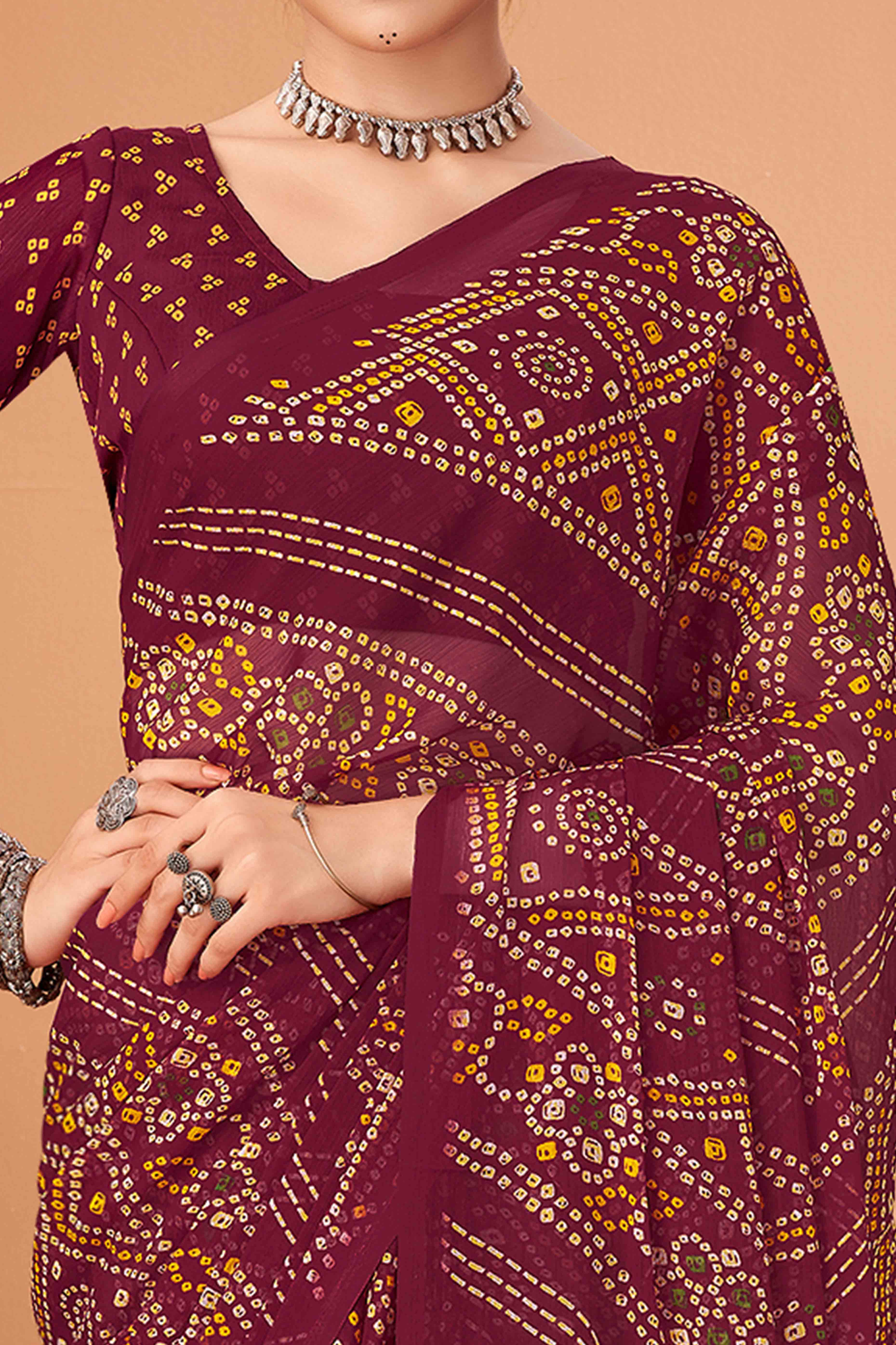 Maroon Bandhani Printed Chiffon Saree Accented With Intricate Lace Border Work