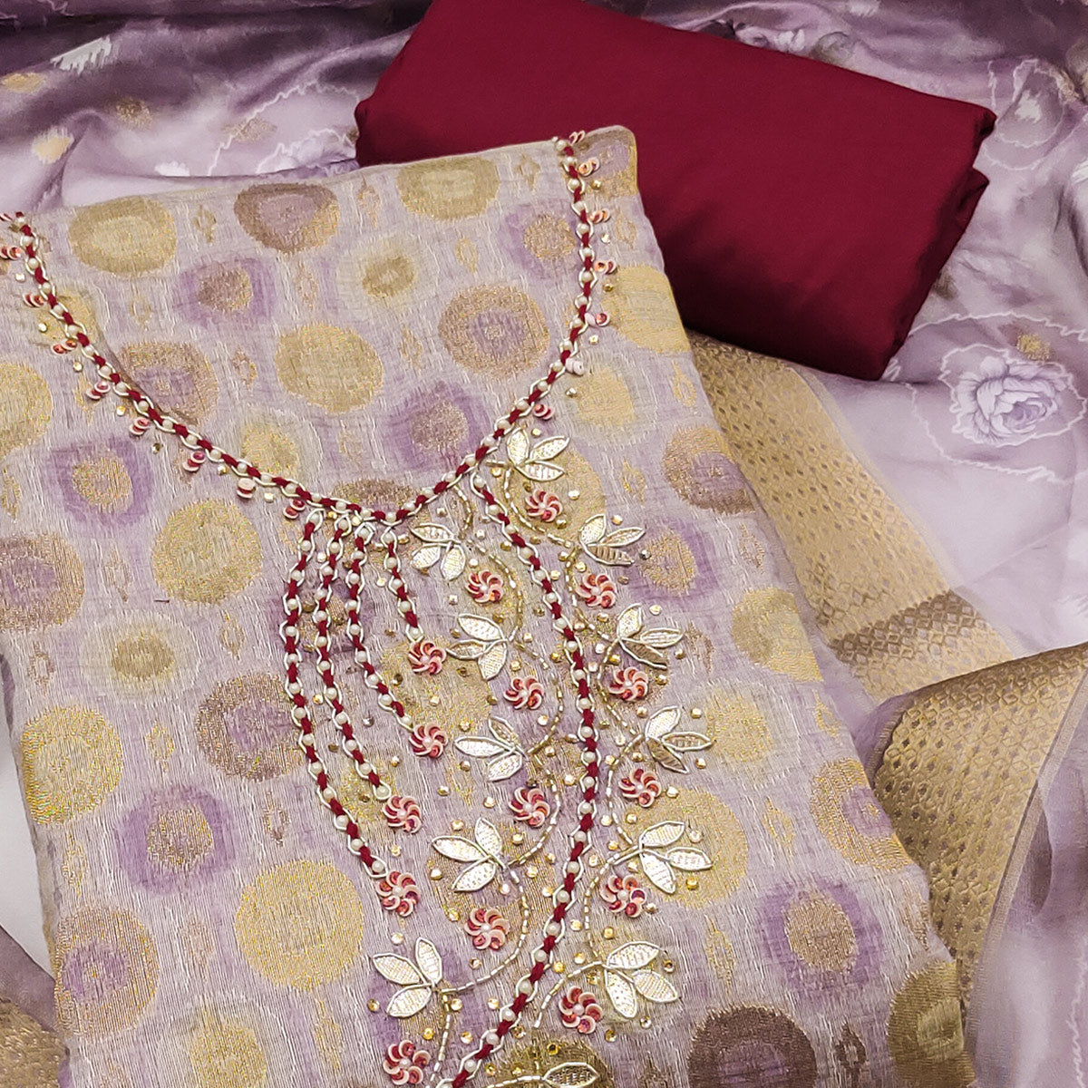 Sophisticated lavender Zari Woven Jacquard Dress Material Highlighted With Floral Handwork