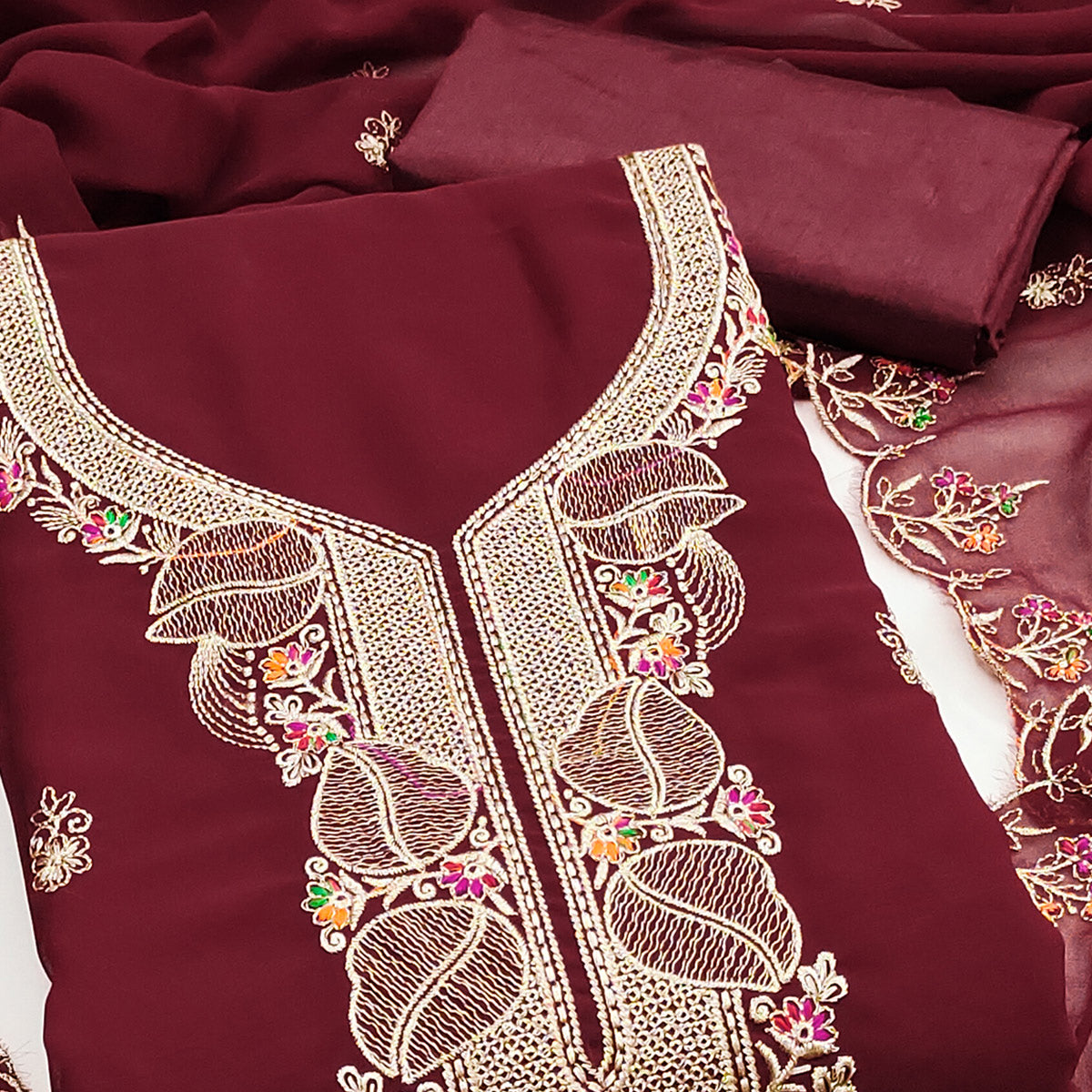 Maroon Georgette Dress Material Adorned With Floral Embroidery & Elegant Lace Border