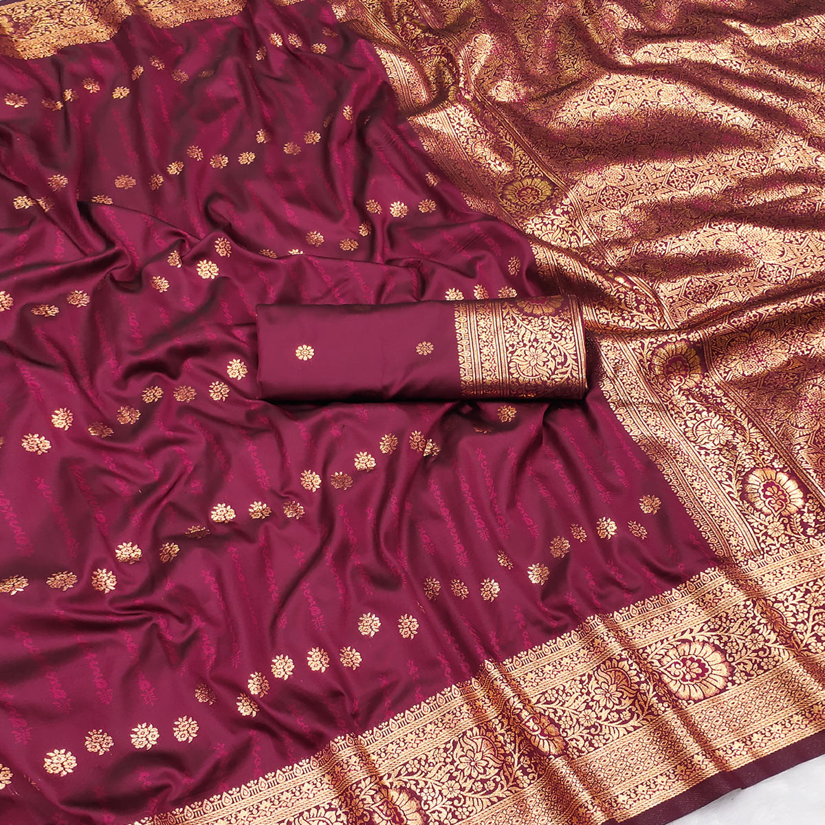 Wine Zari-Woven Cotton Silk Saree Featuring a Graceful Drape and Delicate Tassel Detailing